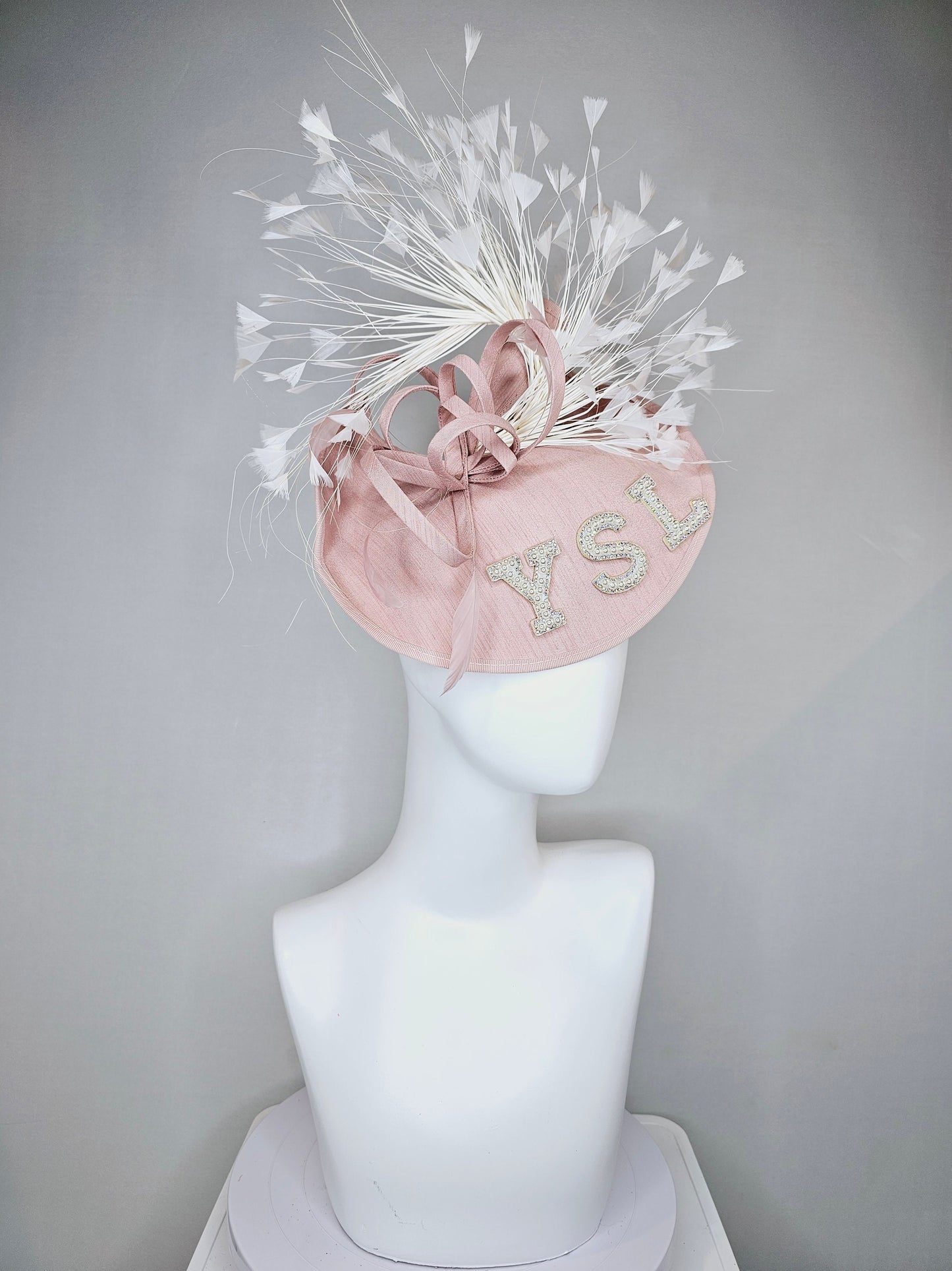 kentucky derby hat fascinator dusty rose blush silk like saucer with white feathers and beaded pearl letters