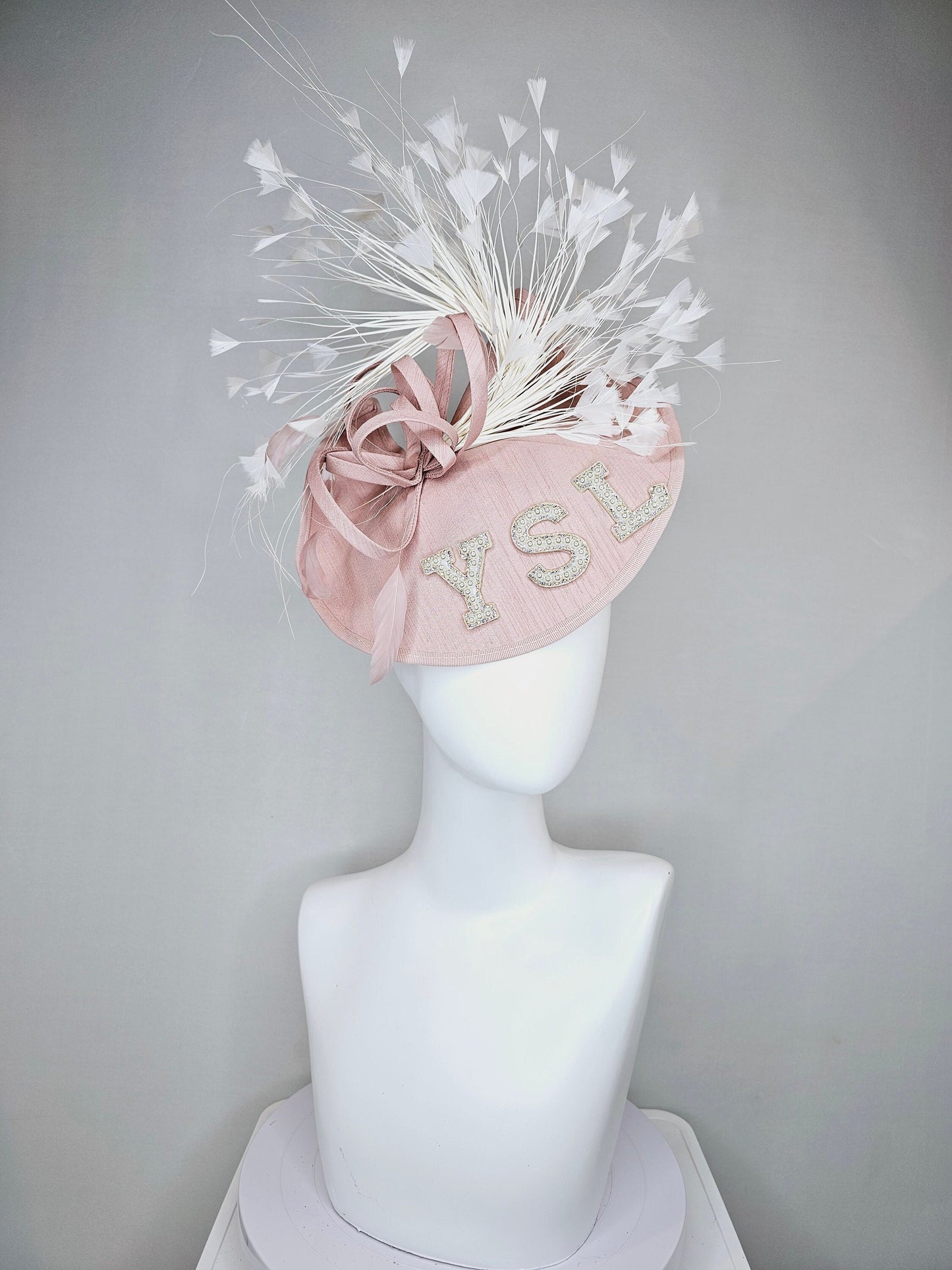 kentucky derby hat fascinator dusty rose blush silk like saucer with white feathers and beaded pearl letters