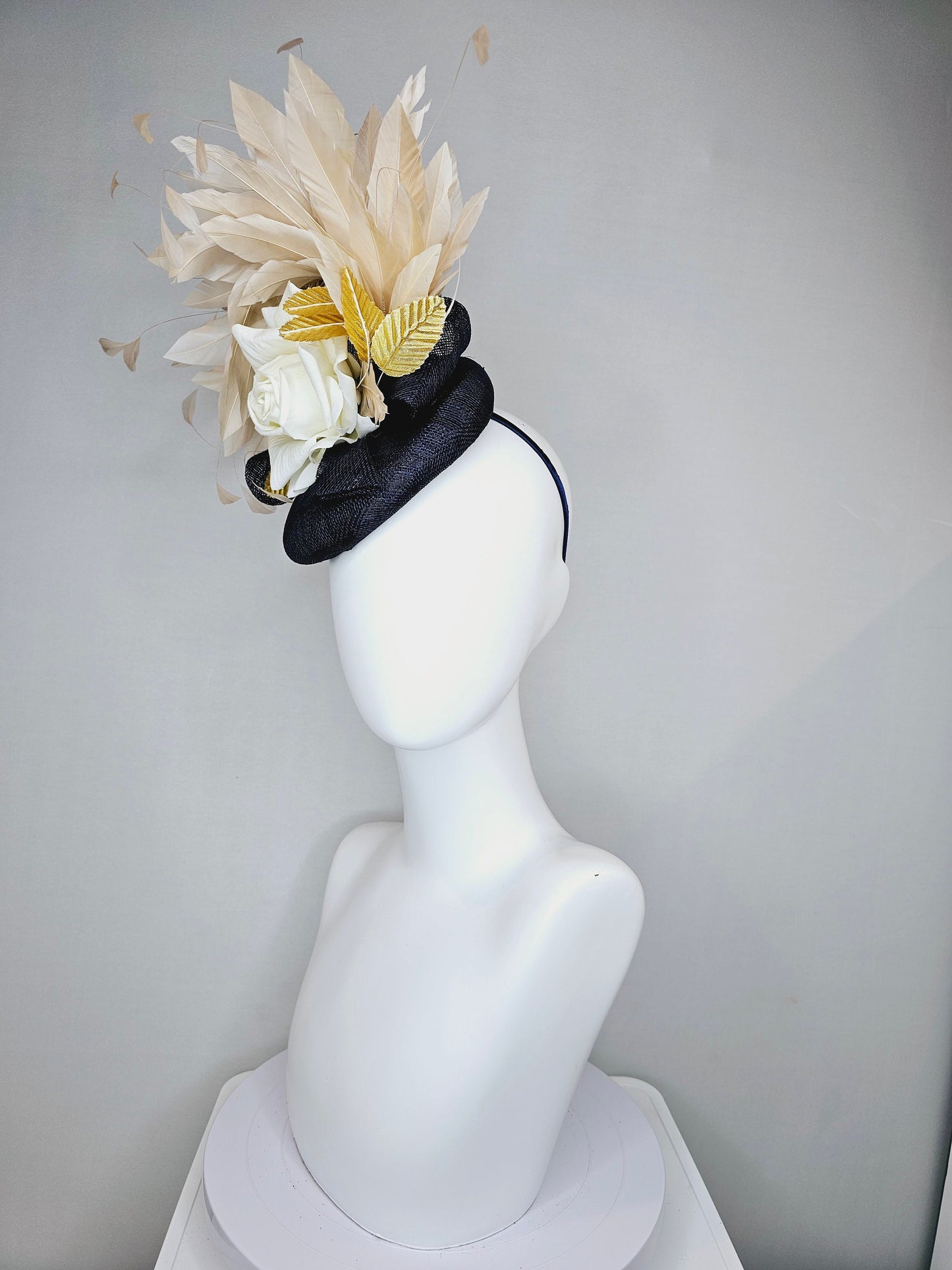 kentucky derby hat fascinator navy sinamay base with white rose and beige light gold peach feathers with bright gold lame leaves