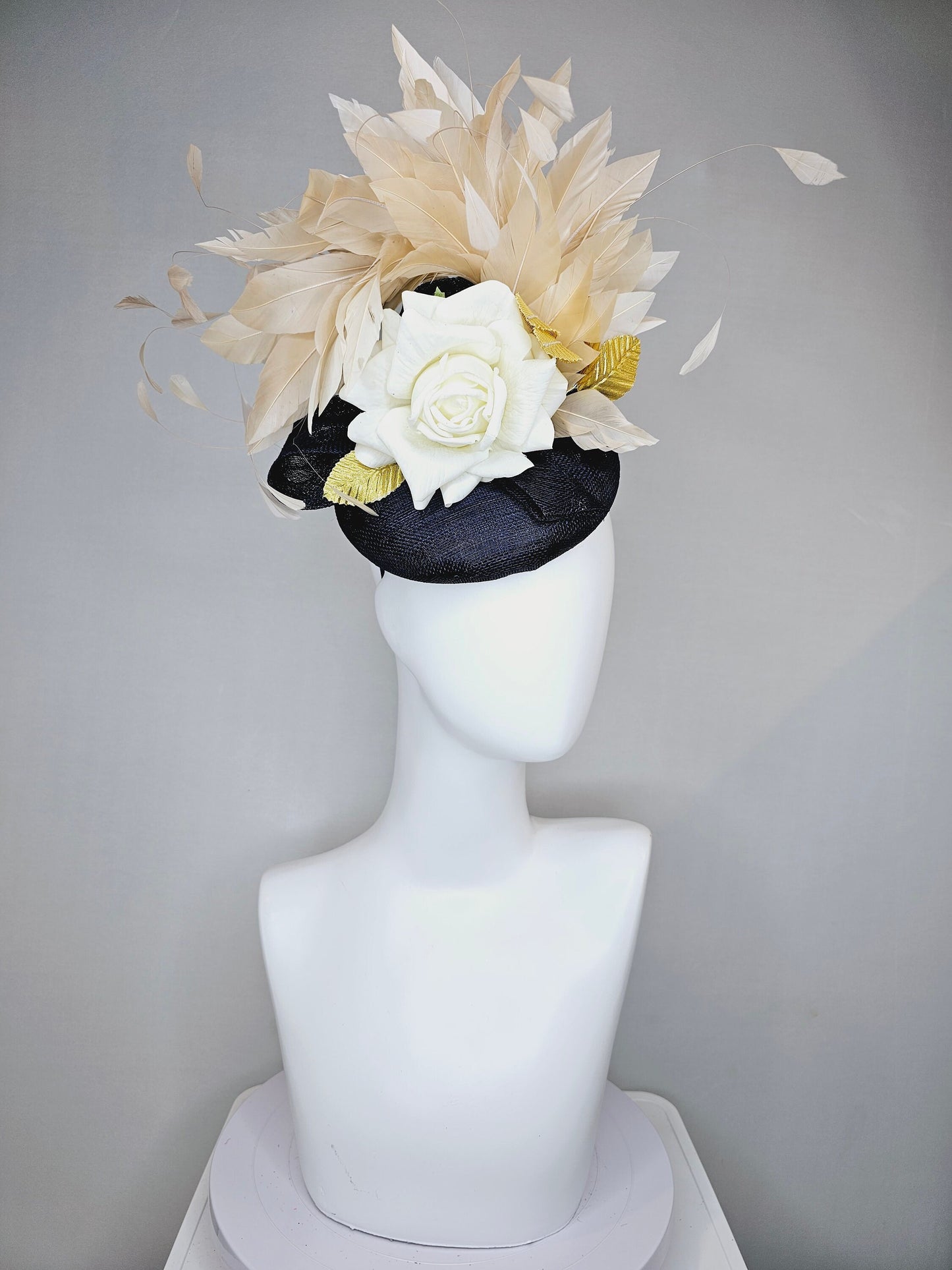 kentucky derby hat fascinator navy sinamay base with white rose and beige light gold peach feathers with bright gold lame leaves