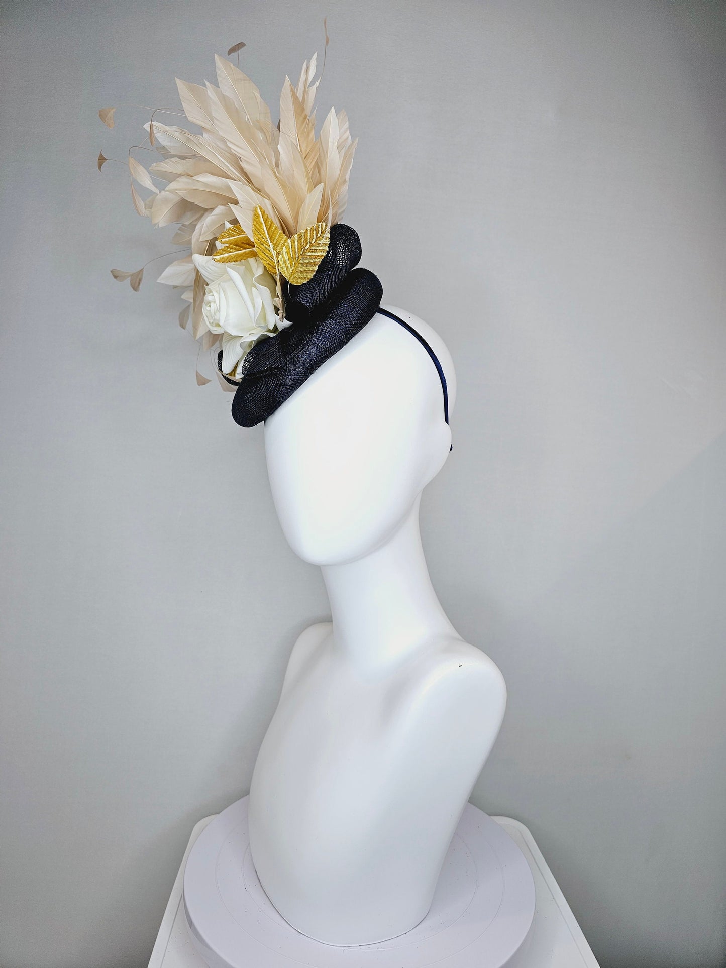 kentucky derby hat fascinator navy sinamay base with white rose and beige light gold peach feathers with bright gold lame leaves