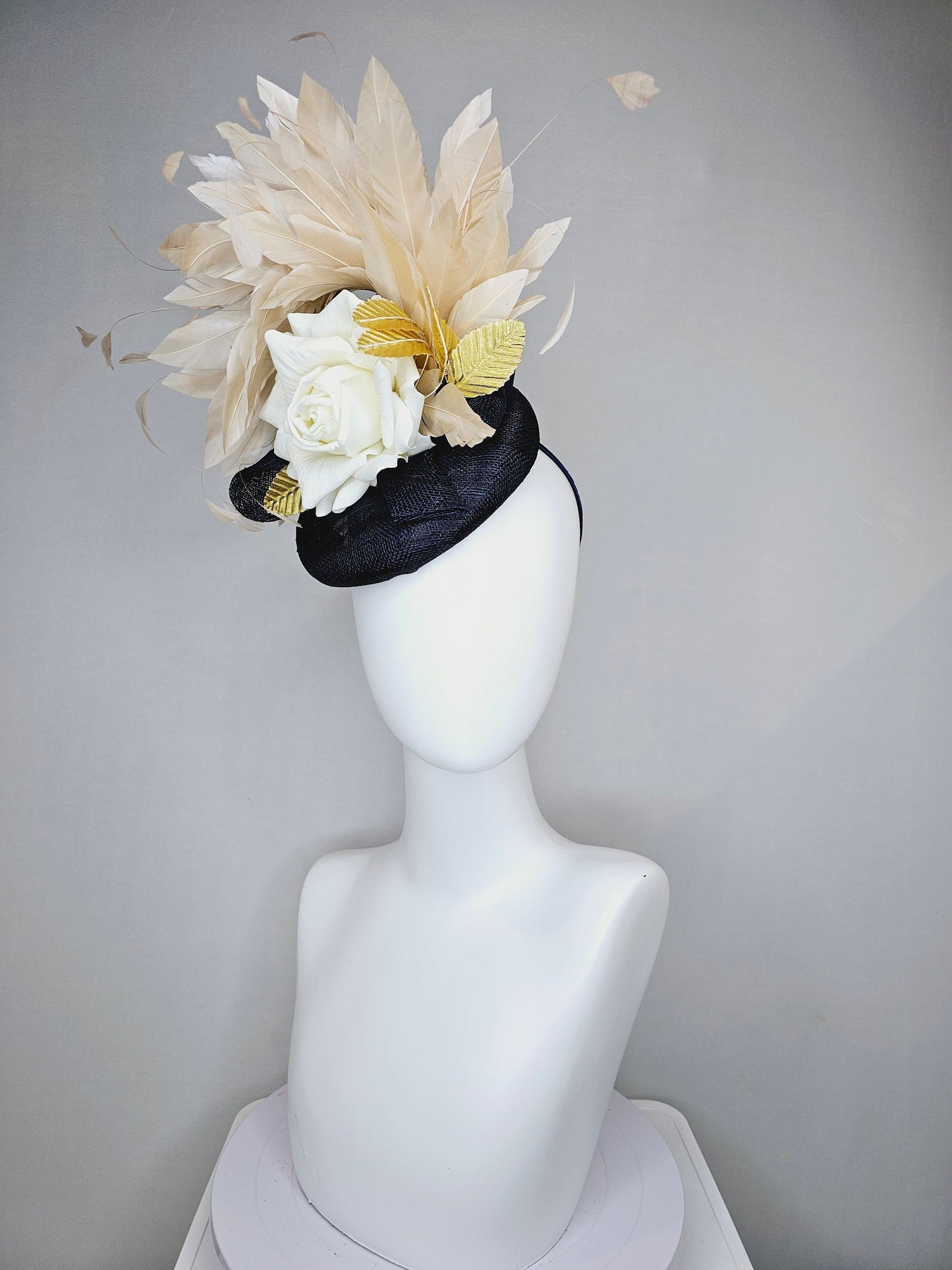 kentucky derby hat fascinator navy sinamay base with white rose and beige light gold peach feathers with bright gold lame leaves