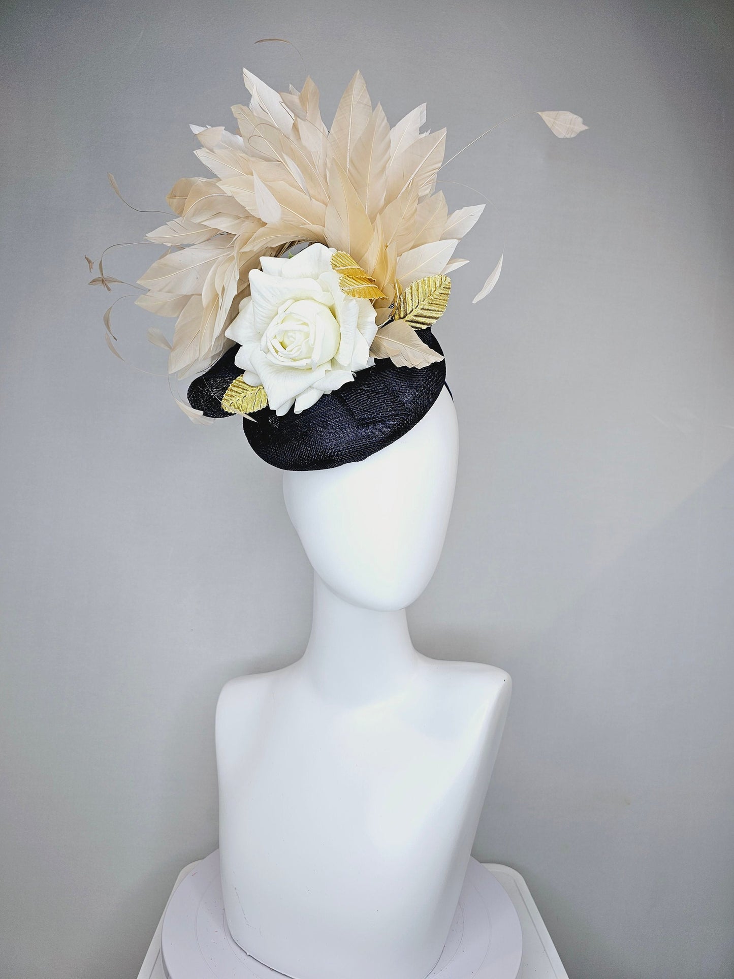 kentucky derby hat fascinator navy sinamay base with white rose and beige light gold peach feathers with bright gold lame leaves