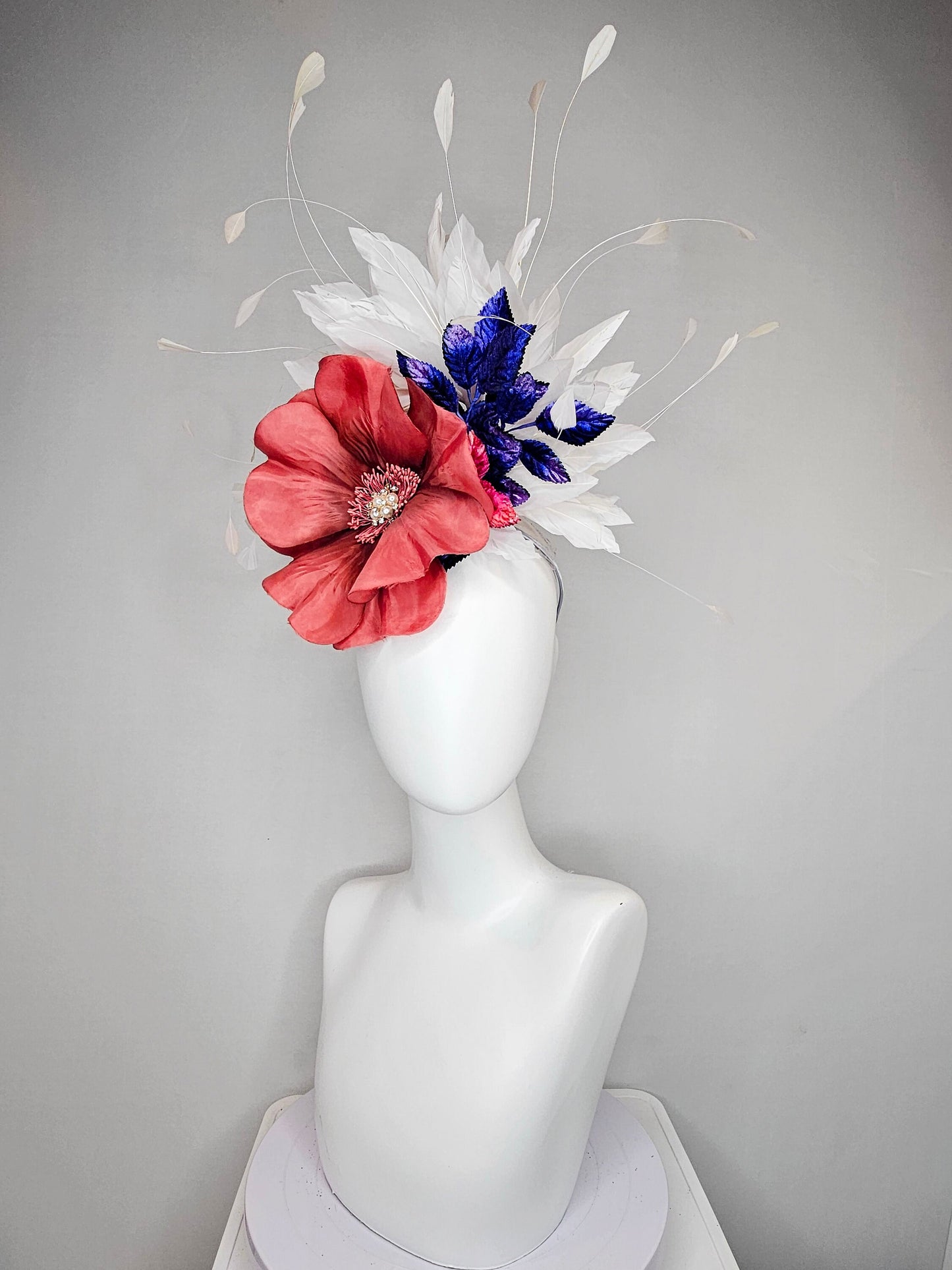 kentucky derby hat fascinator hat coral sinamay base large coral burnt orange flower with white feathers purple royal blue pink leaves