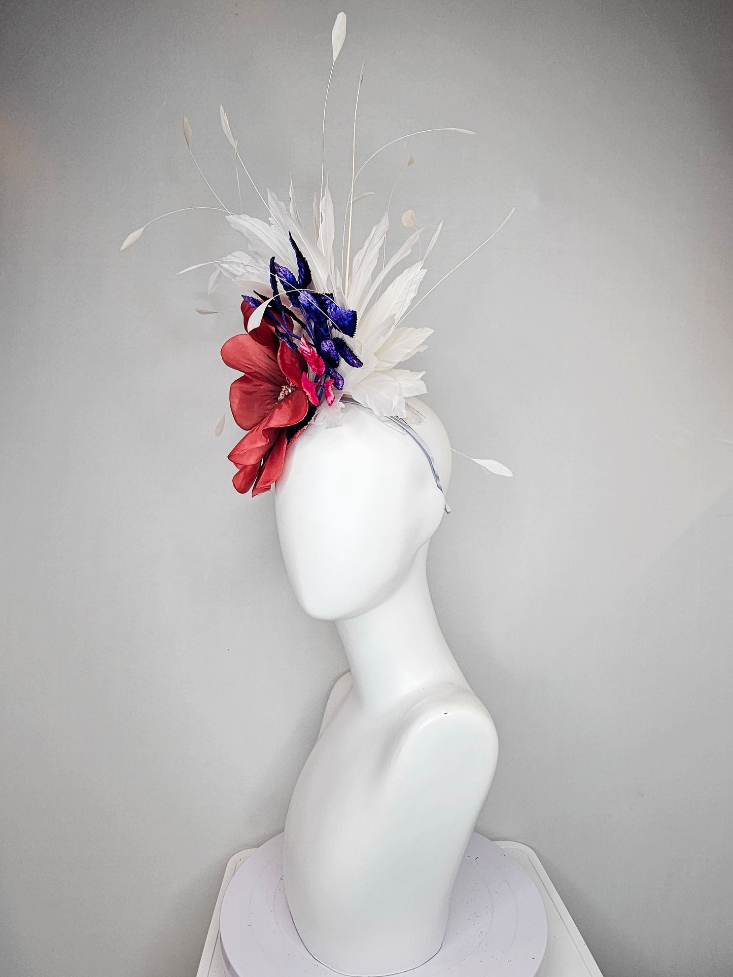 kentucky derby hat fascinator hat coral sinamay base large coral burnt orange flower with white feathers purple royal blue pink leaves