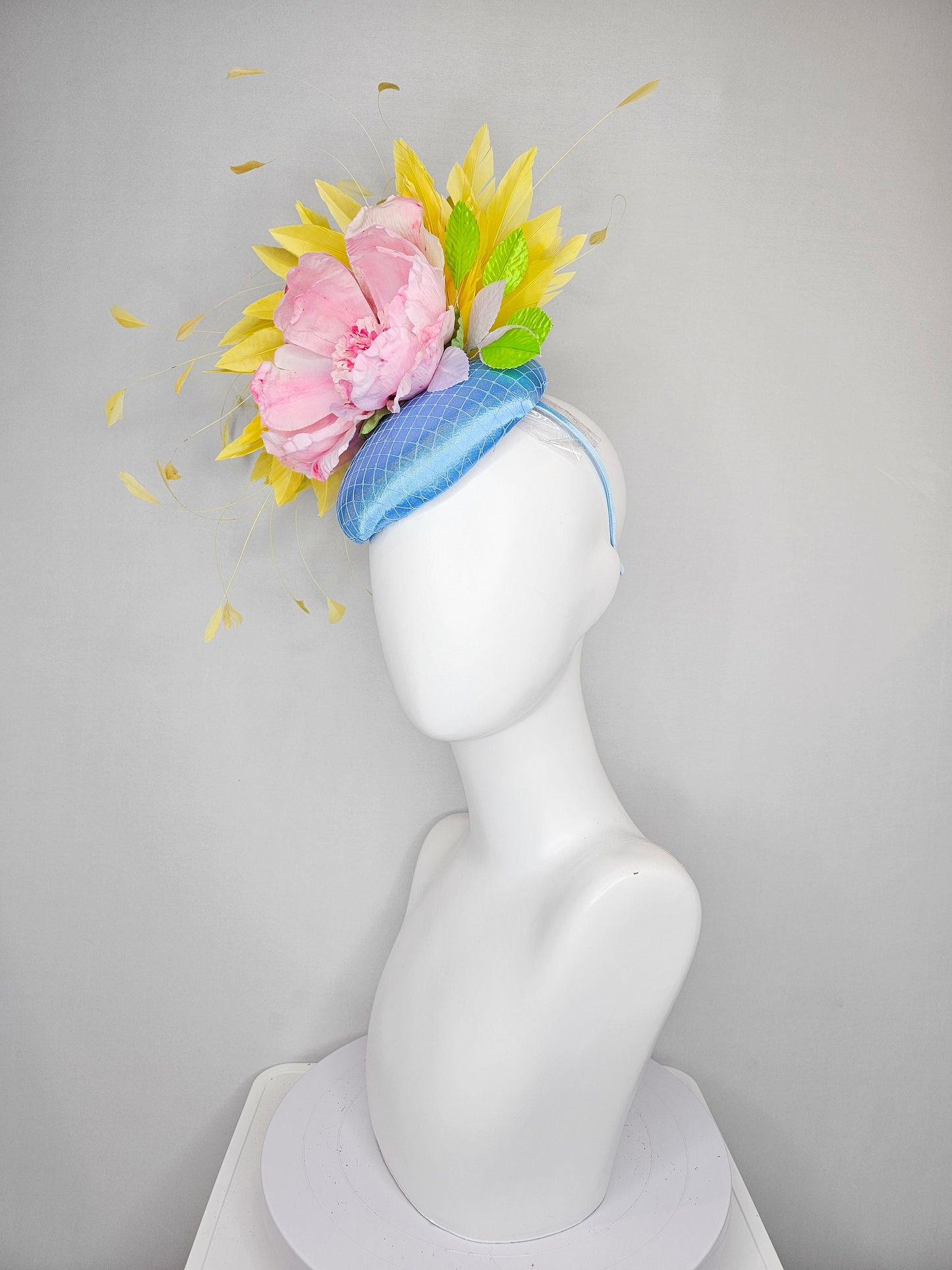 kentucky derby hat fascinator light blue satin with large light pink flowers bright green leaves and yellow feathers