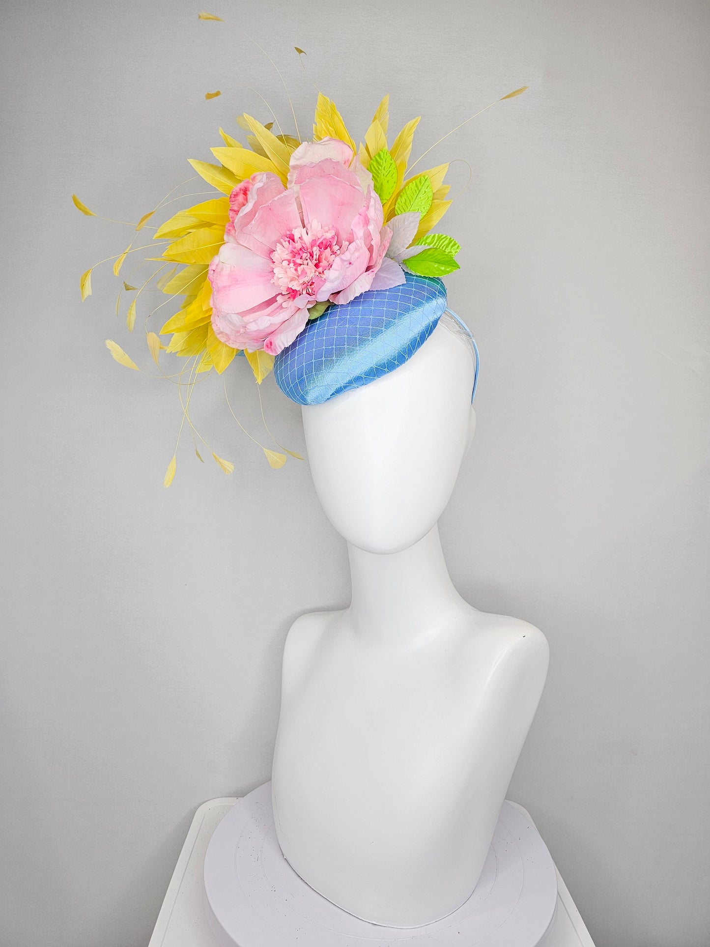 kentucky derby hat fascinator light blue satin with large light pink flowers bright green leaves and yellow feathers