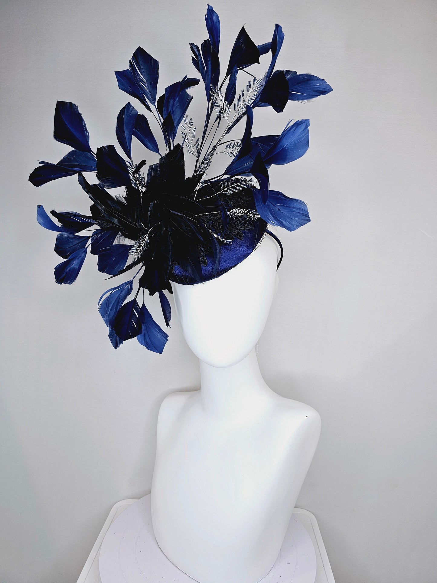 kentucky derby hat fascinator navy blue satin with embroidery with navy blue feathers and feather flower with branching silver beaded decor