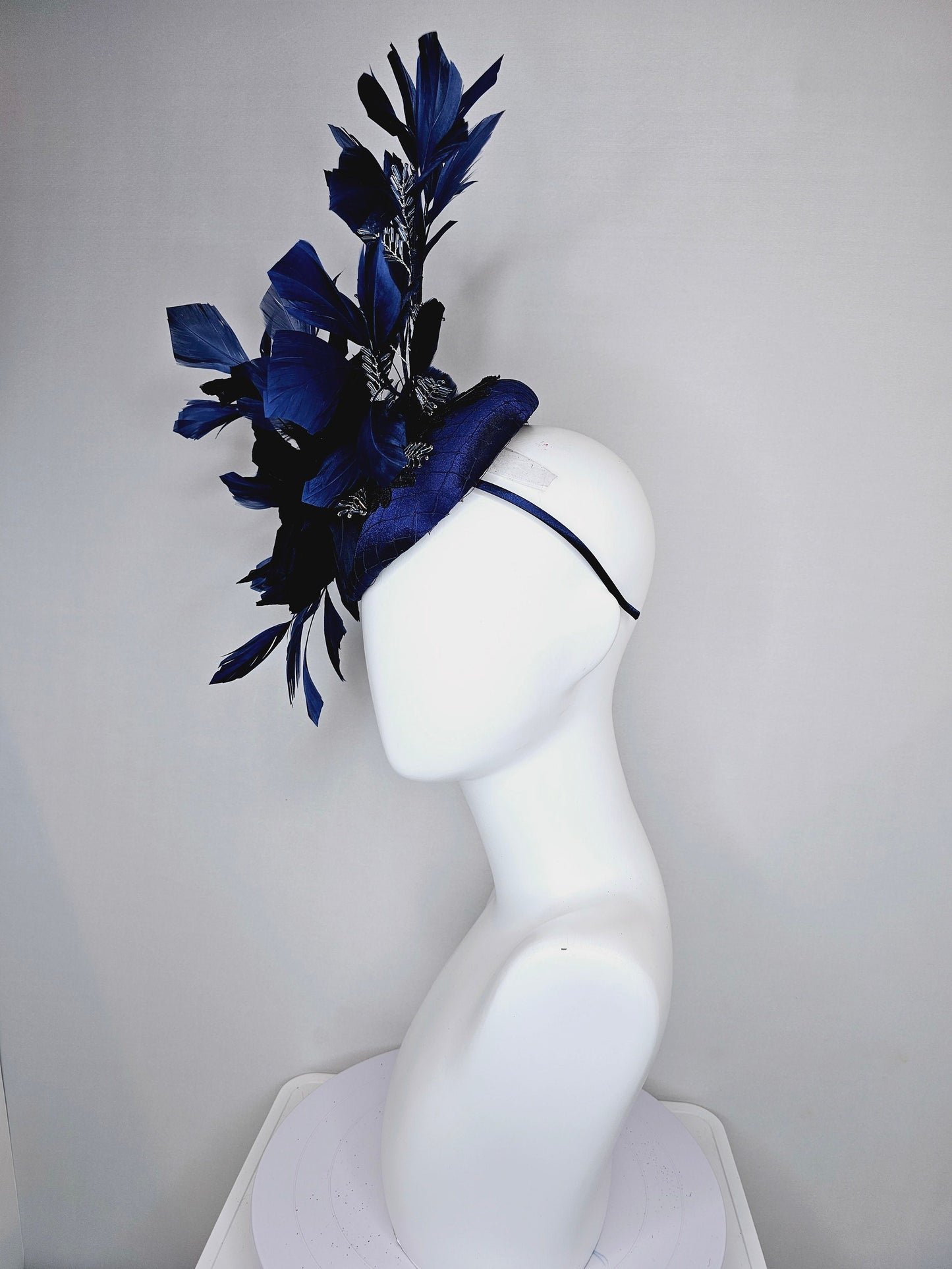 kentucky derby hat fascinator navy blue satin with embroidery with navy blue feathers and feather flower with branching silver beaded decor