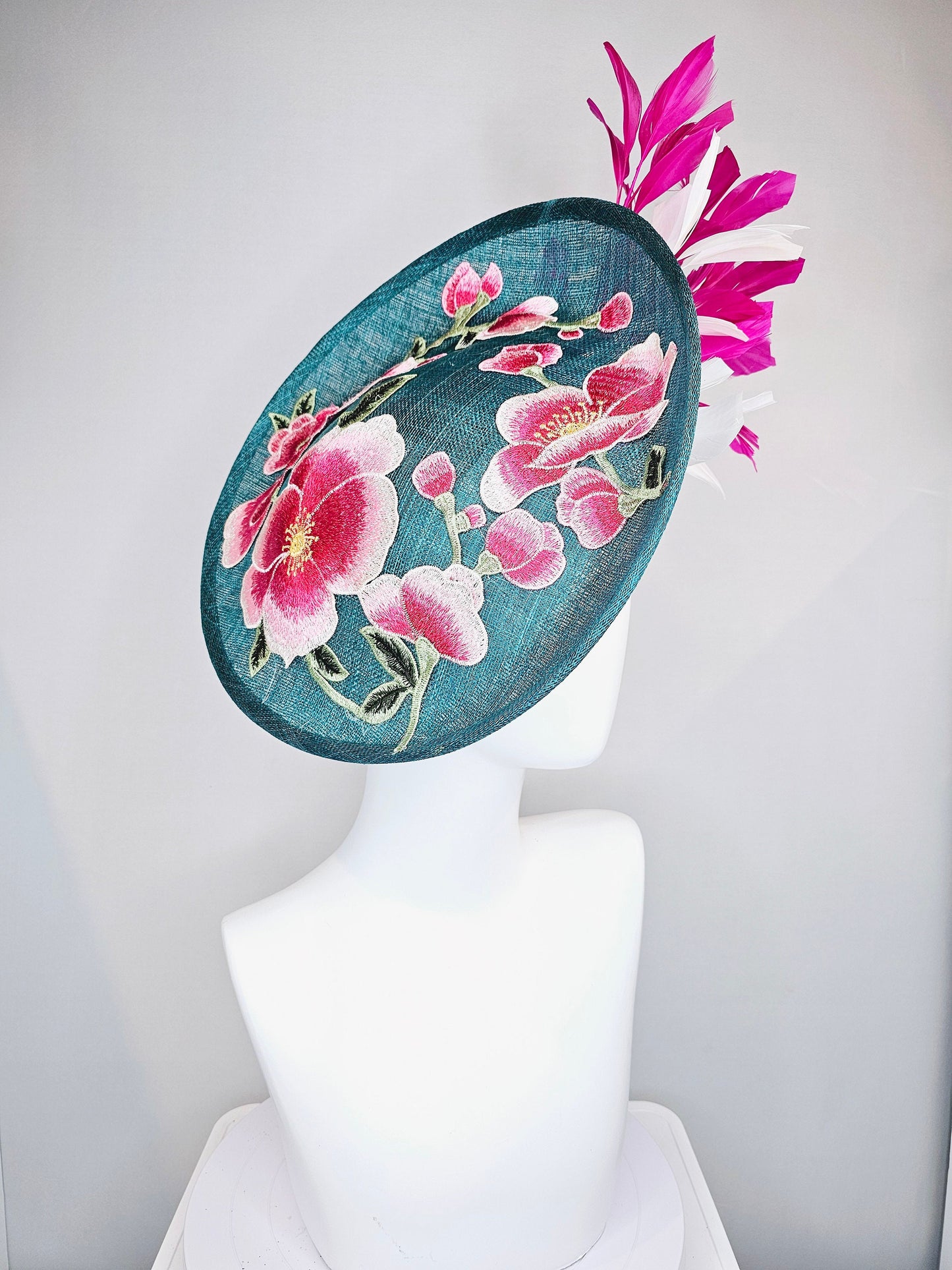 kentucky derby hat fascinator teal blue sinamay saucer with fuchsia pink and white feathers and pink white gold embroidered flowers