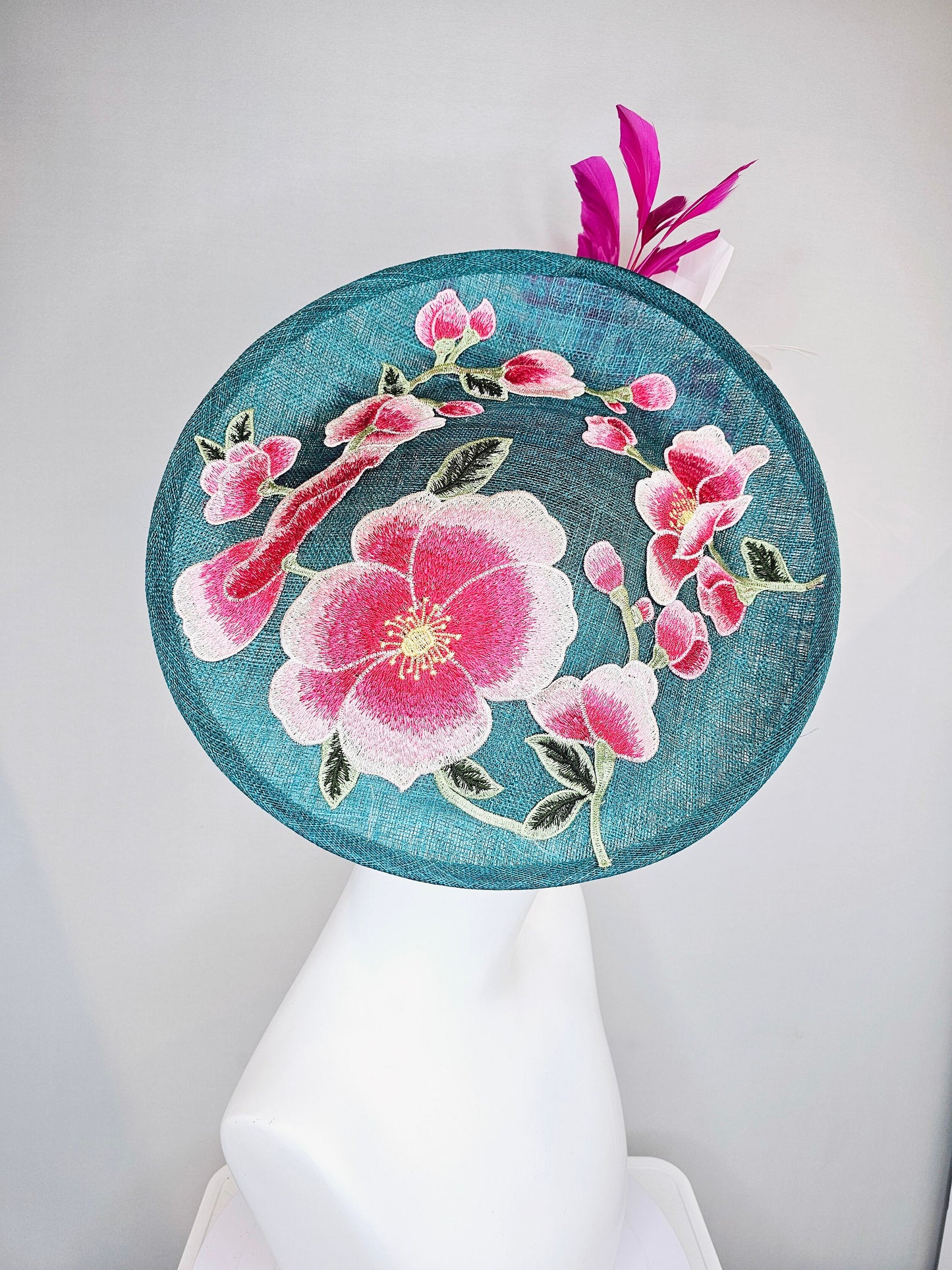 kentucky derby hat fascinator teal blue sinamay saucer with fuchsia pink and white feathers and pink white gold embroidered flowers