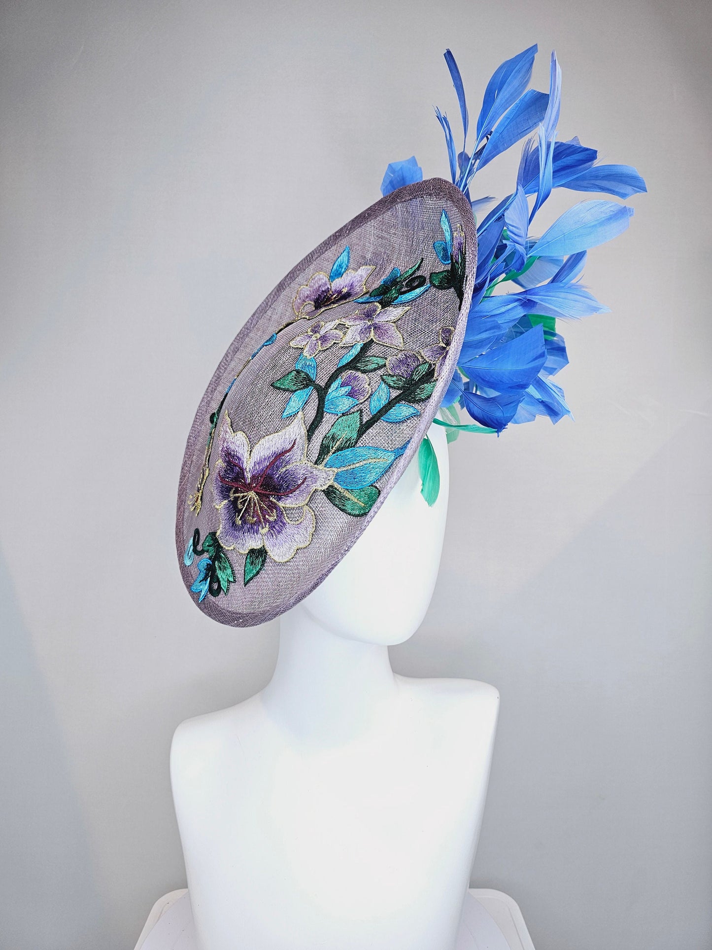 kentucky derby hat fascinator light purple lavender sinamay saucer with blue green feathers and blue green  gold embroidered flowers