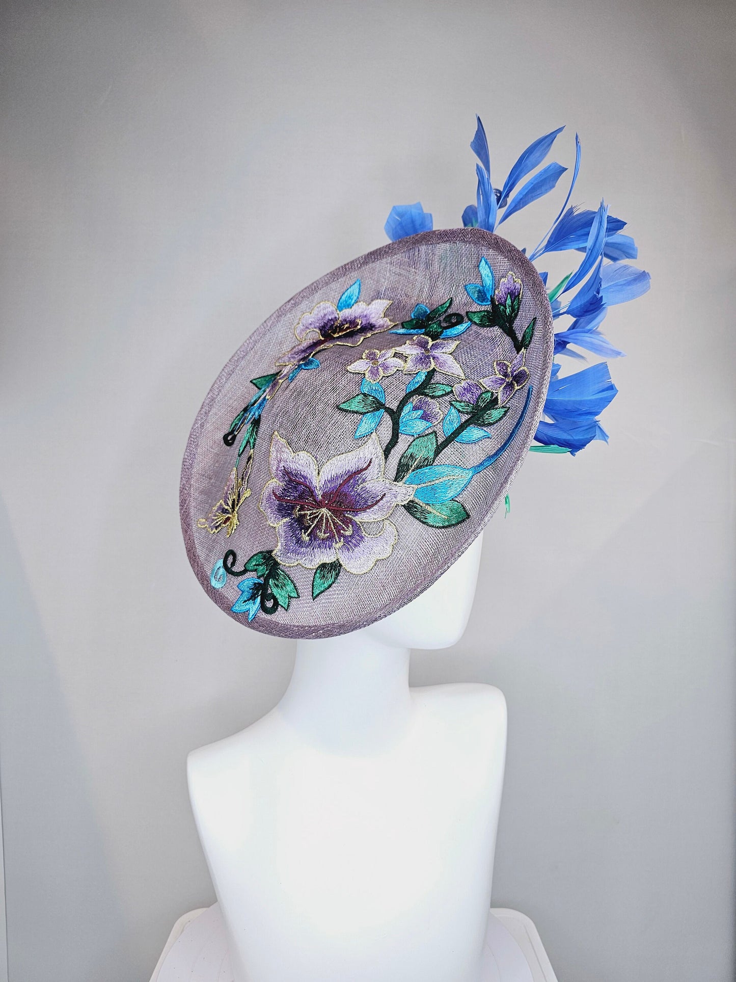 kentucky derby hat fascinator light purple lavender sinamay saucer with blue green feathers and blue green  gold embroidered flowers