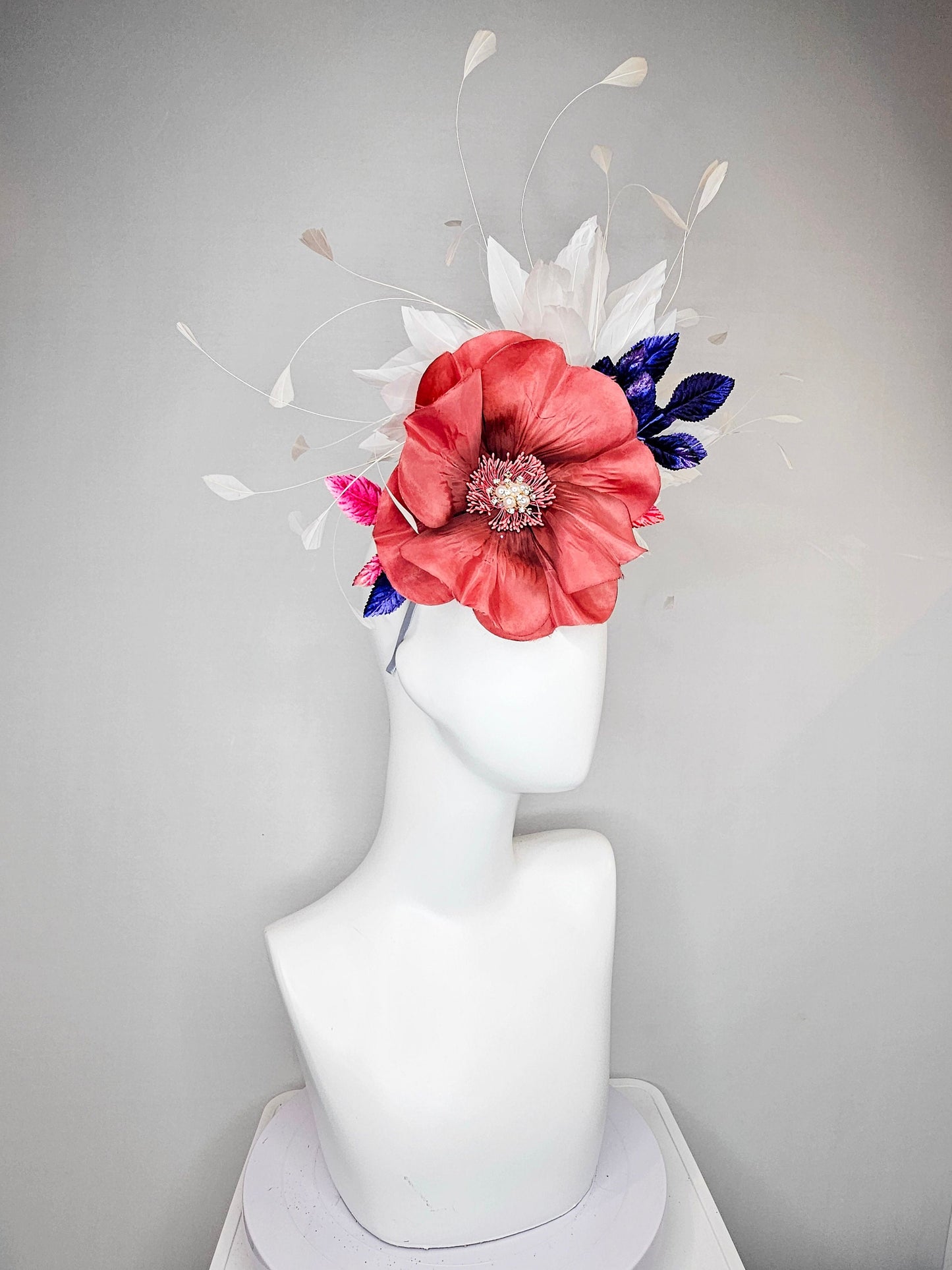 kentucky derby hat fascinator hat coral sinamay base large coral burnt orange flower with white feathers purple royal blue pink leaves