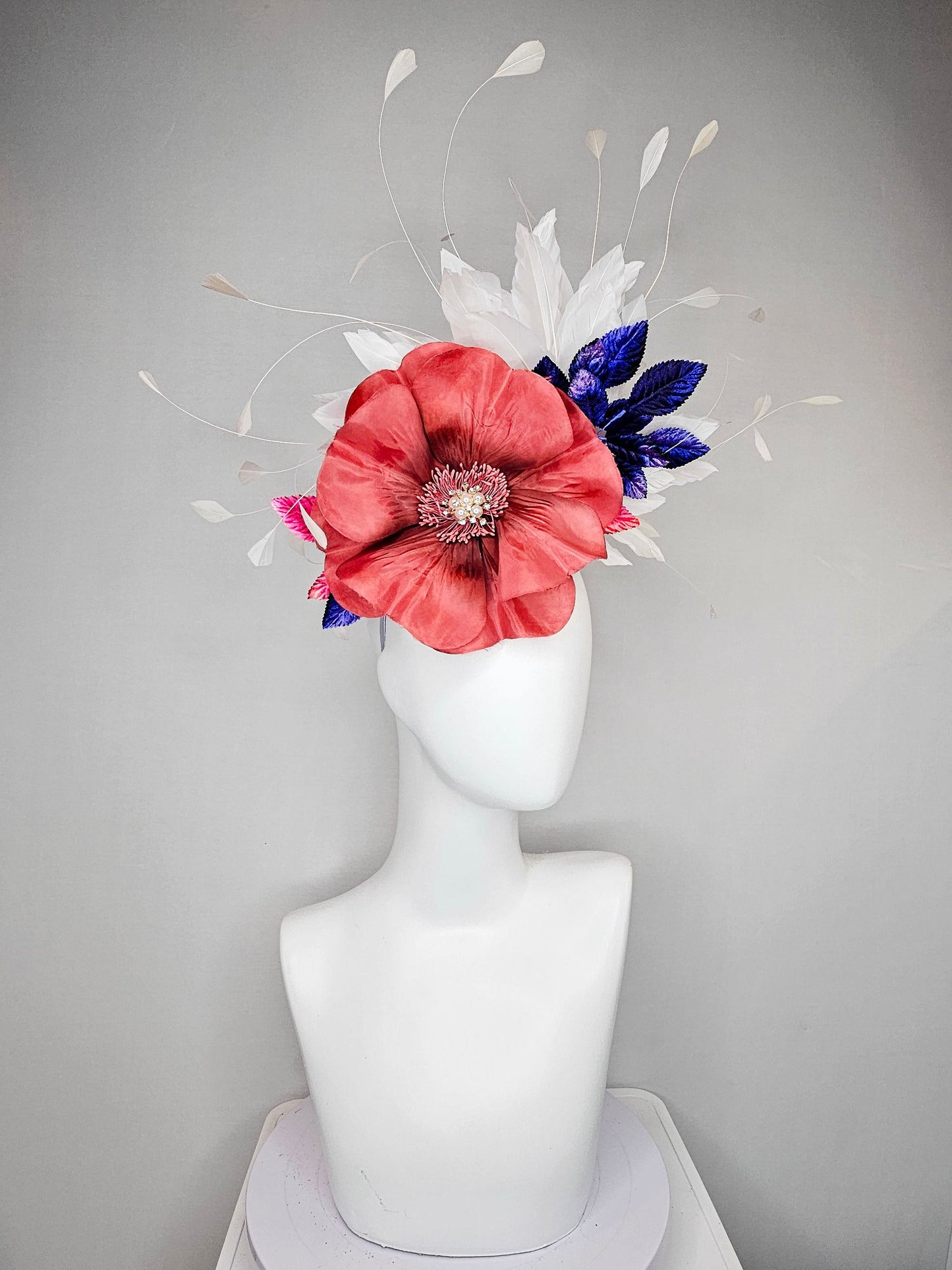 kentucky derby hat fascinator hat coral sinamay base large coral burnt orange flower with white feathers purple royal blue pink leaves