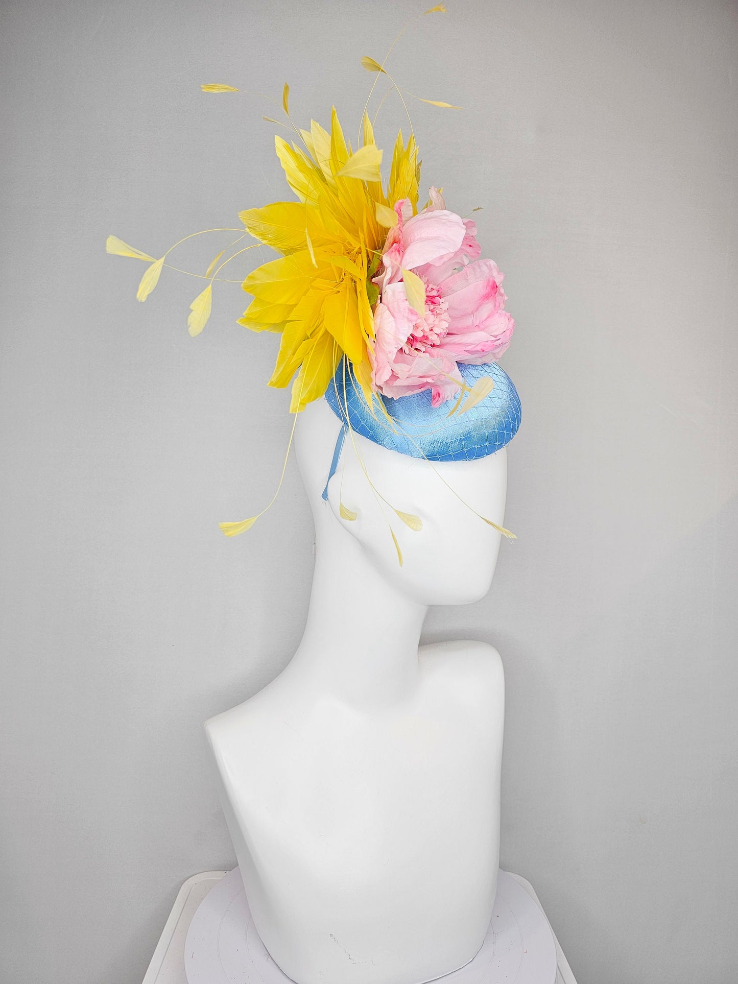 kentucky derby hat fascinator light blue satin with large light pink flowers bright green leaves and yellow feathers