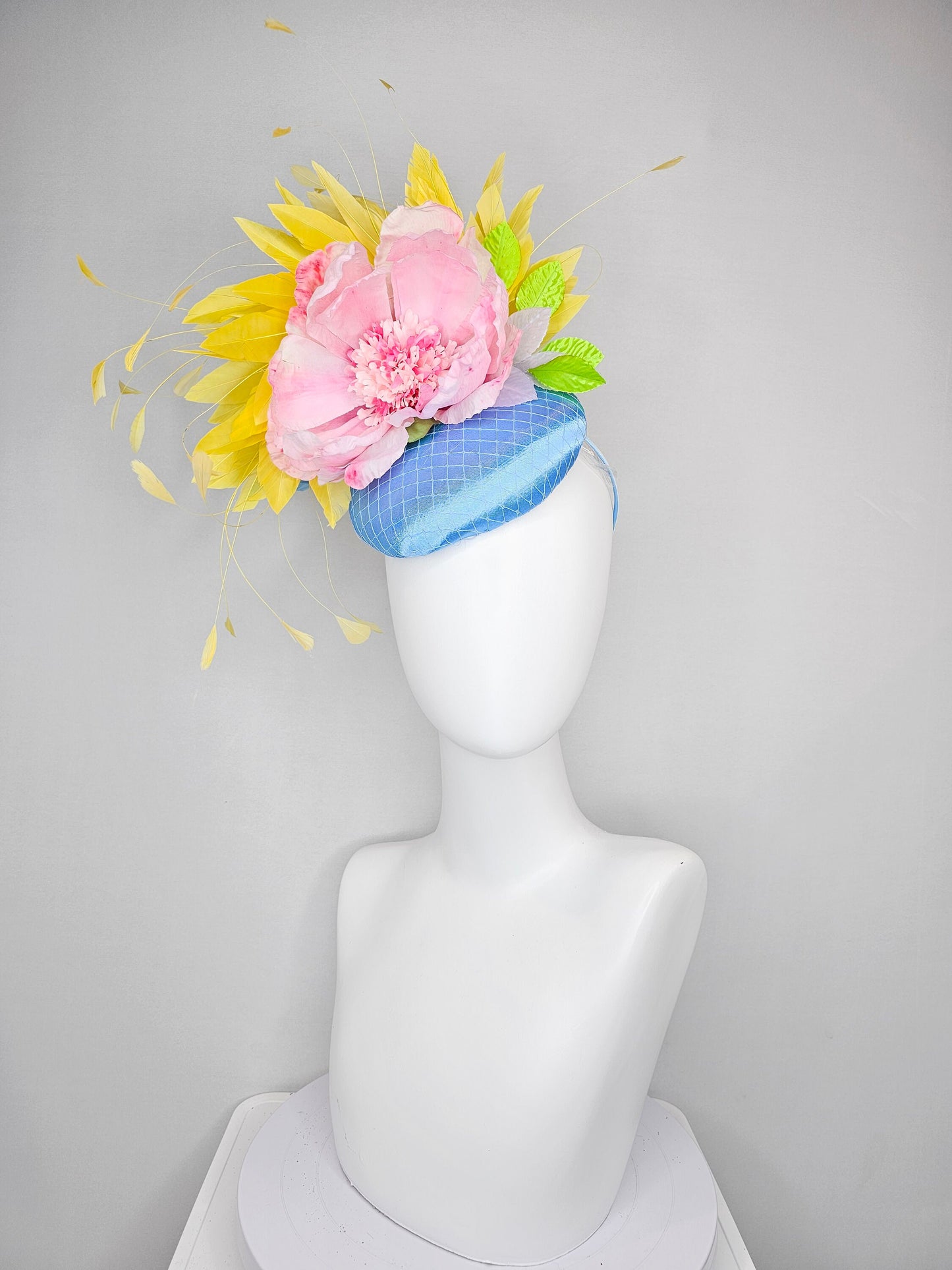 kentucky derby hat fascinator light blue satin with large light pink flowers bright green leaves and yellow feathers