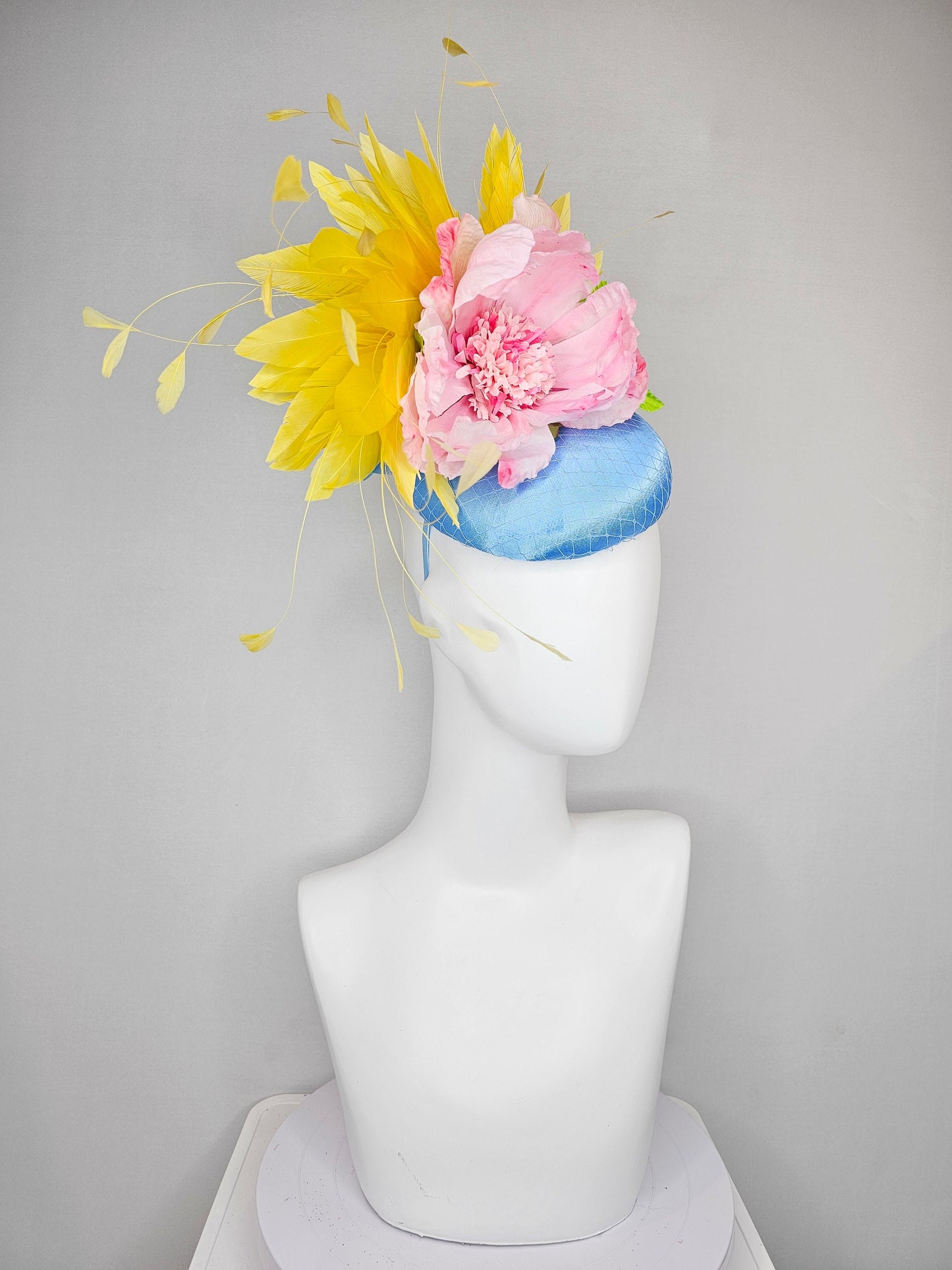 kentucky derby hat fascinator light blue satin with large light pink flowers bright green leaves and yellow feathers