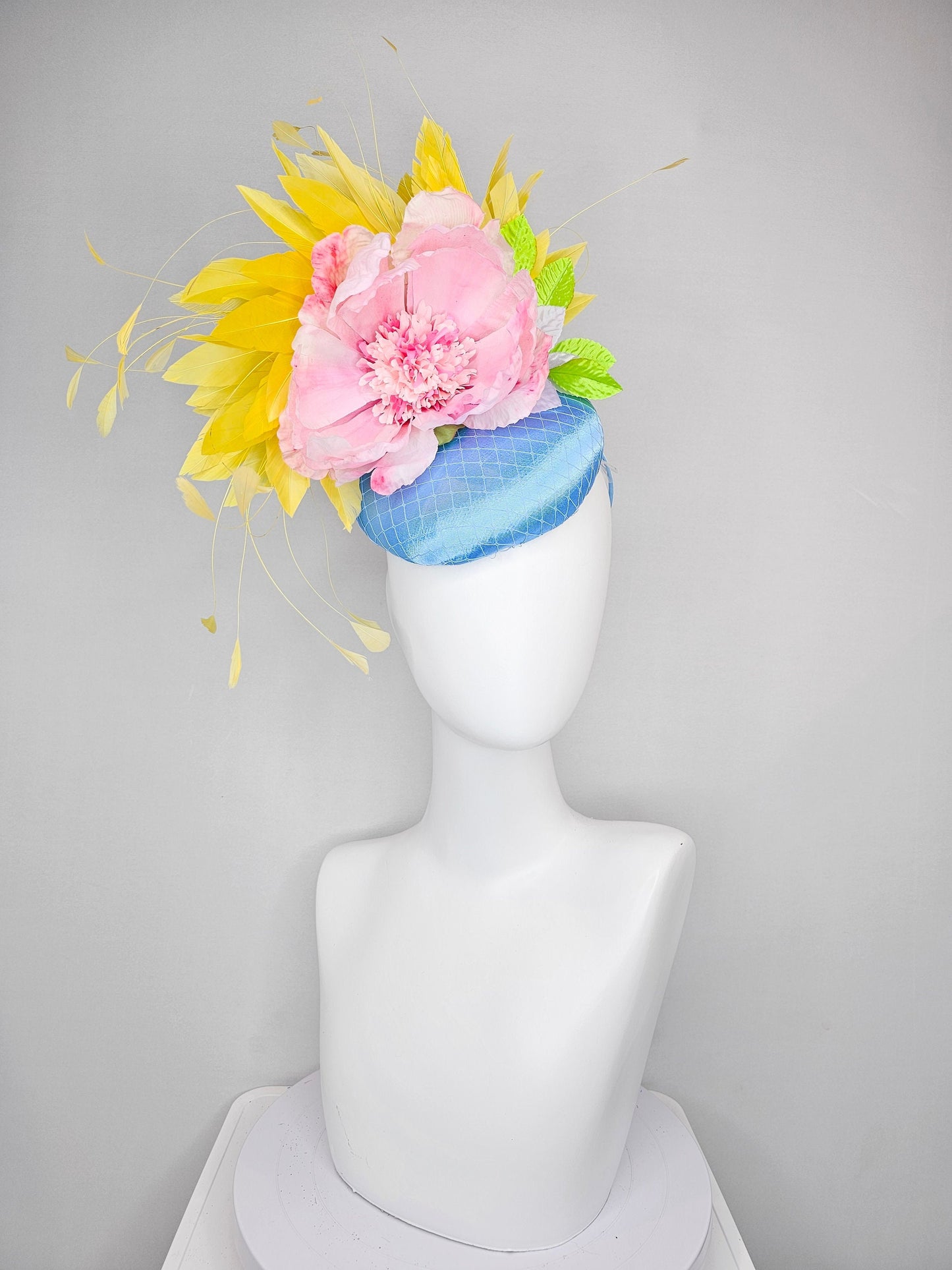 kentucky derby hat fascinator light blue satin with large light pink flowers bright green leaves and yellow feathers