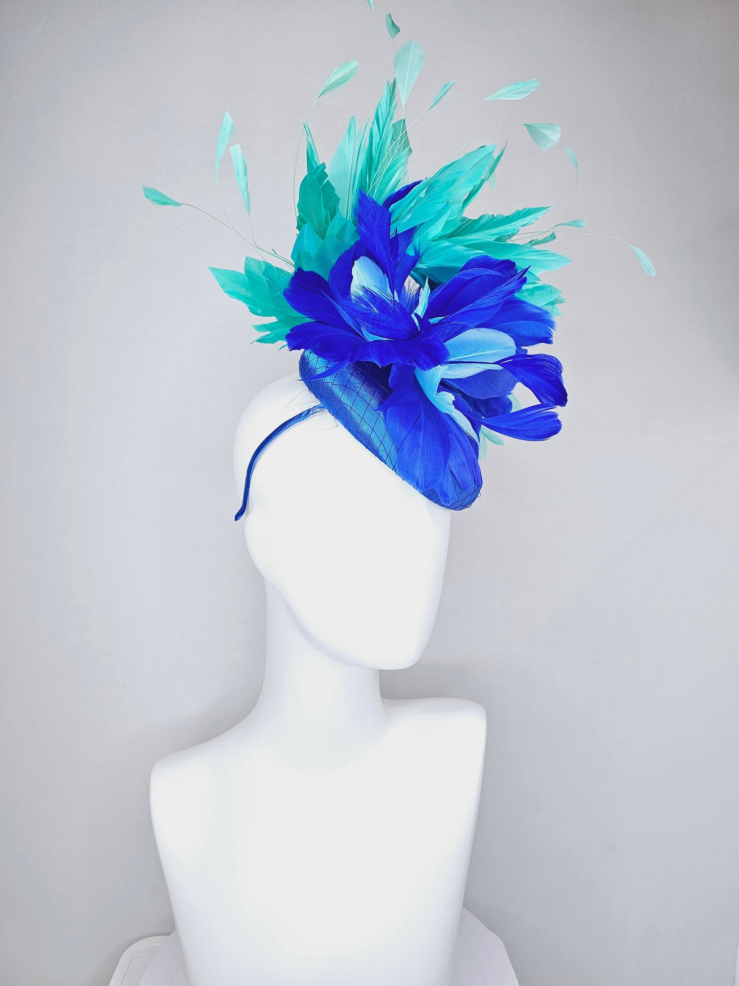 kentucky derby hat fascinator royal blue satin with green feathers and blue green feather flowers