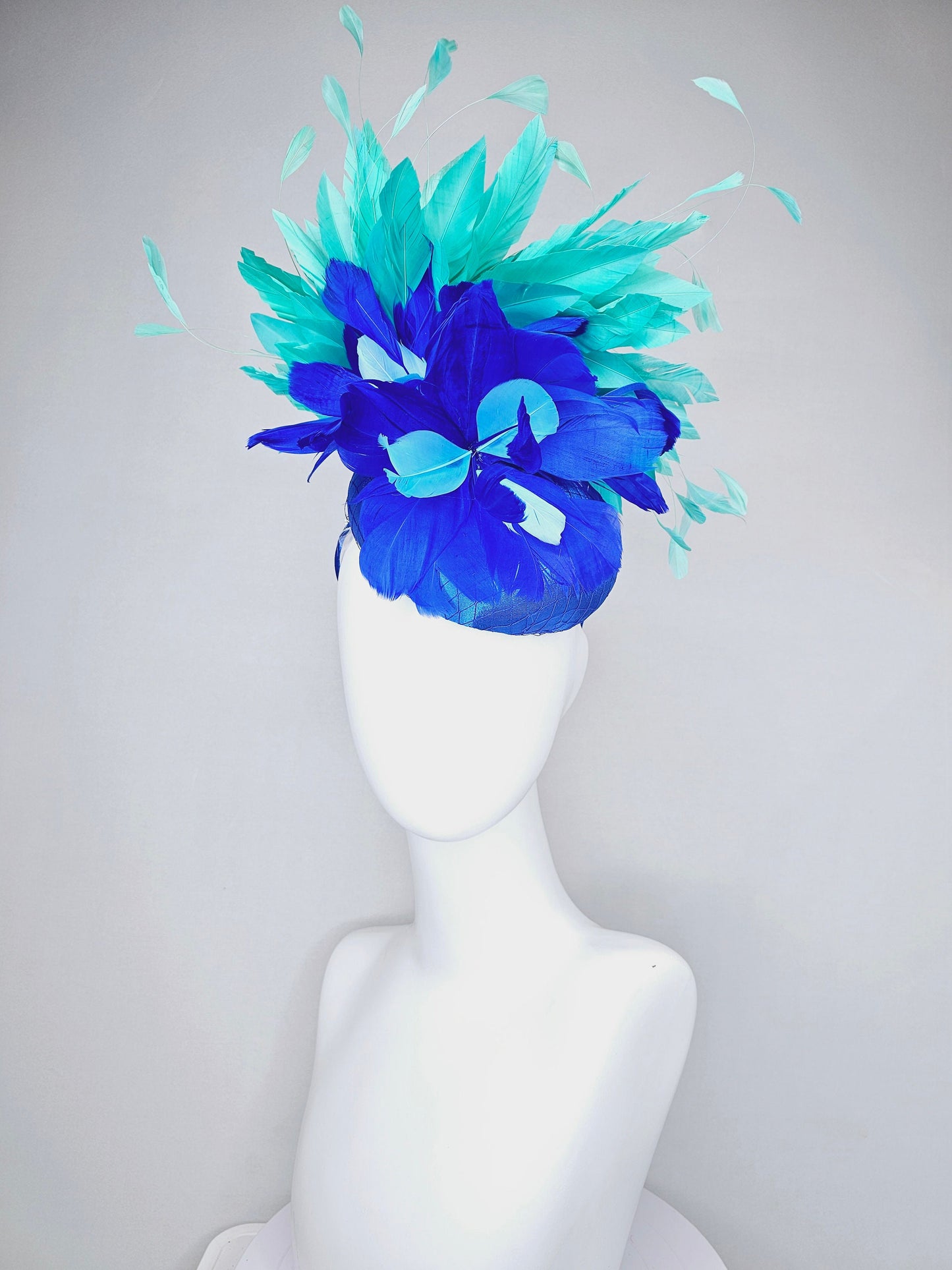 kentucky derby hat fascinator royal blue satin with green feathers and blue green feather flowers