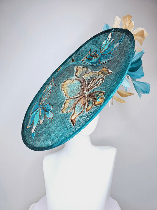 kentucky derby hat fascinator teal blue sinamay saucer with gold and teal peacock blue green feathers and teal gold embroidered flowers