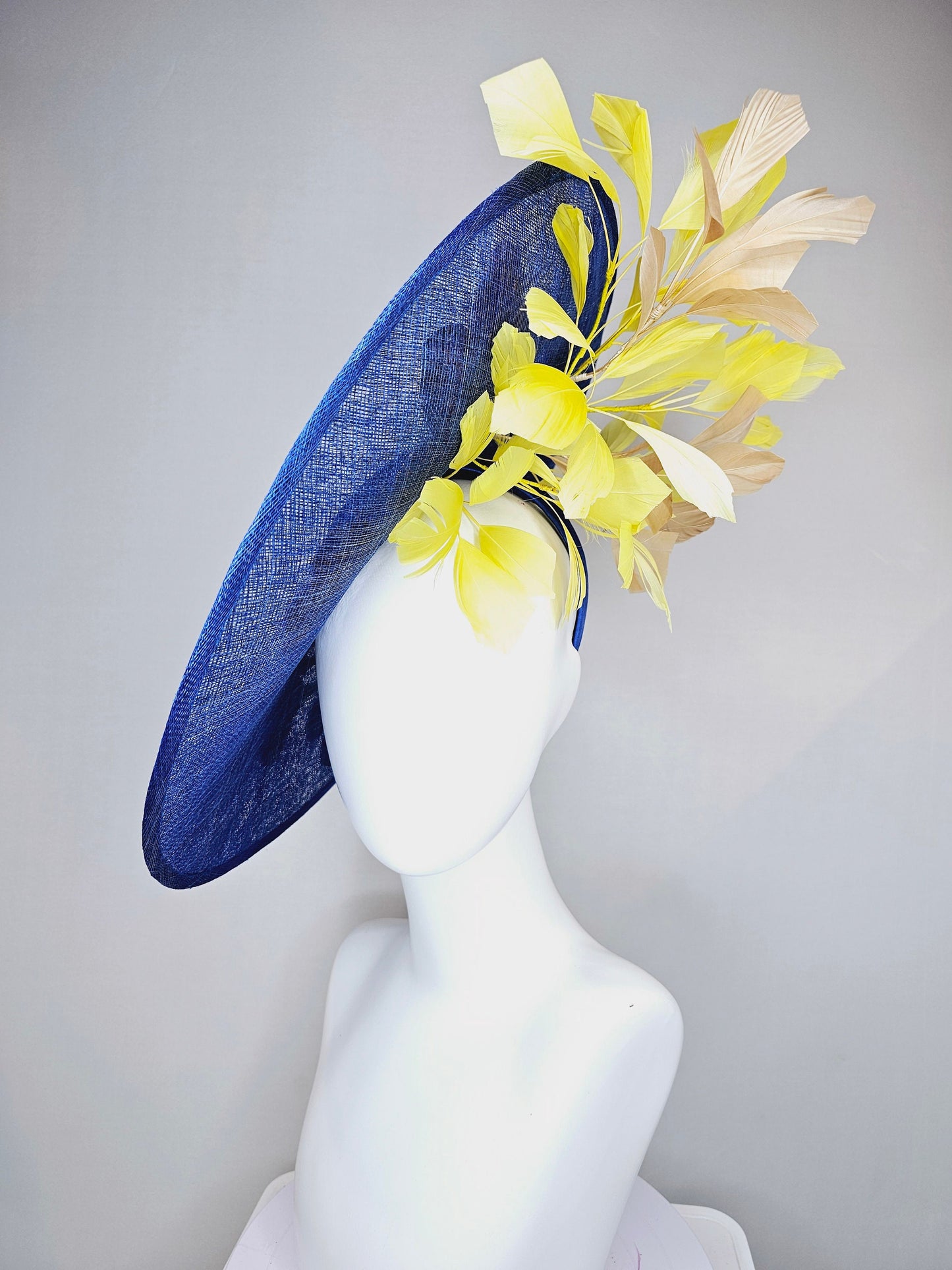 kentucky derby hat fascinator blue sinamay large saucer with yellow and gold taupe feathers and white pink yellow embroidered flowers