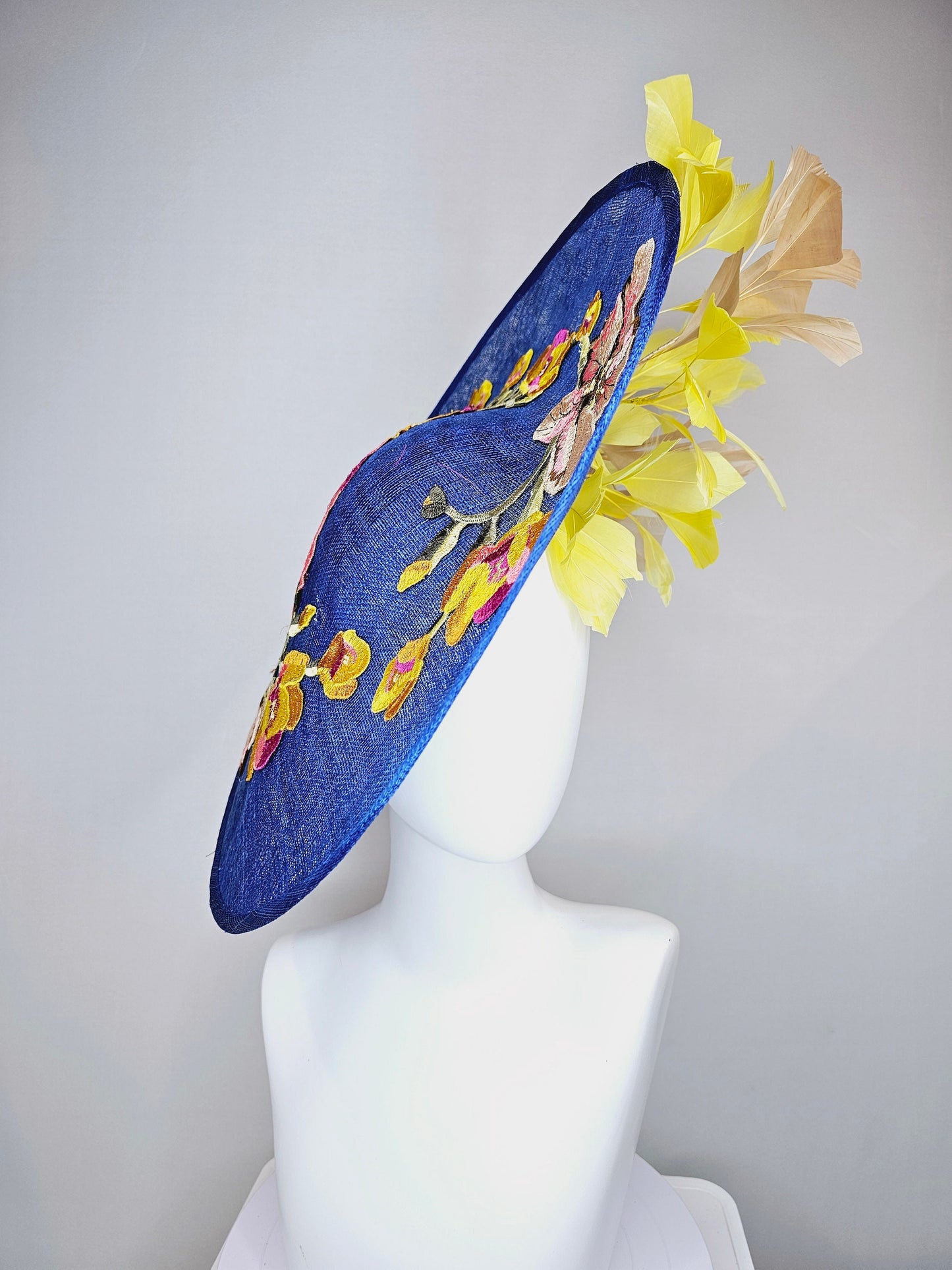 kentucky derby hat fascinator blue sinamay large saucer with yellow and gold taupe feathers and white pink yellow embroidered flowers