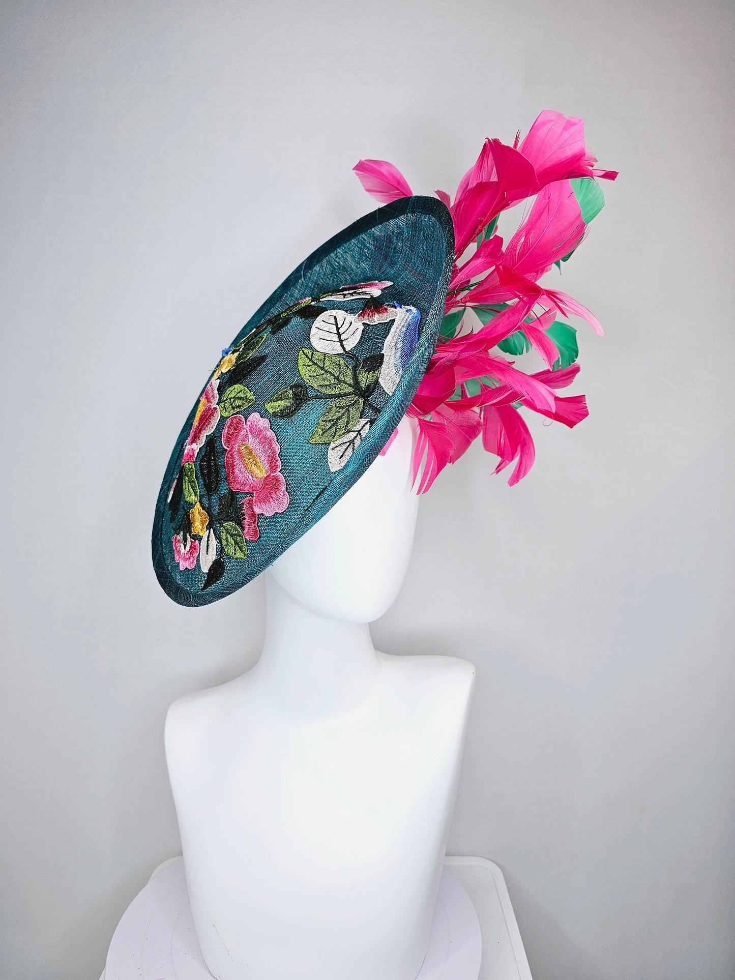 kentucky derby hat fascinator teal sinamay saucer with fuchsia pink and green feathers and yellow pink blue embroidered flowers and birds