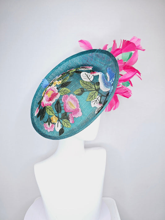 kentucky derby hat fascinator teal sinamay saucer with fuchsia pink and green feathers and yellow pink blue embroidered flowers and birds