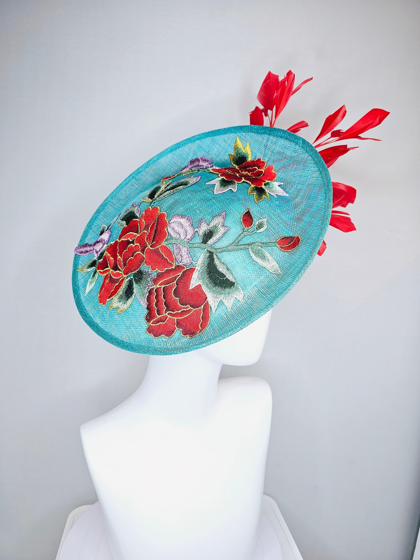 kentucky derby hat fascinator teal turquoise aqua blue sinamay saucer with purple red gold green embroidered flowers with red feathers