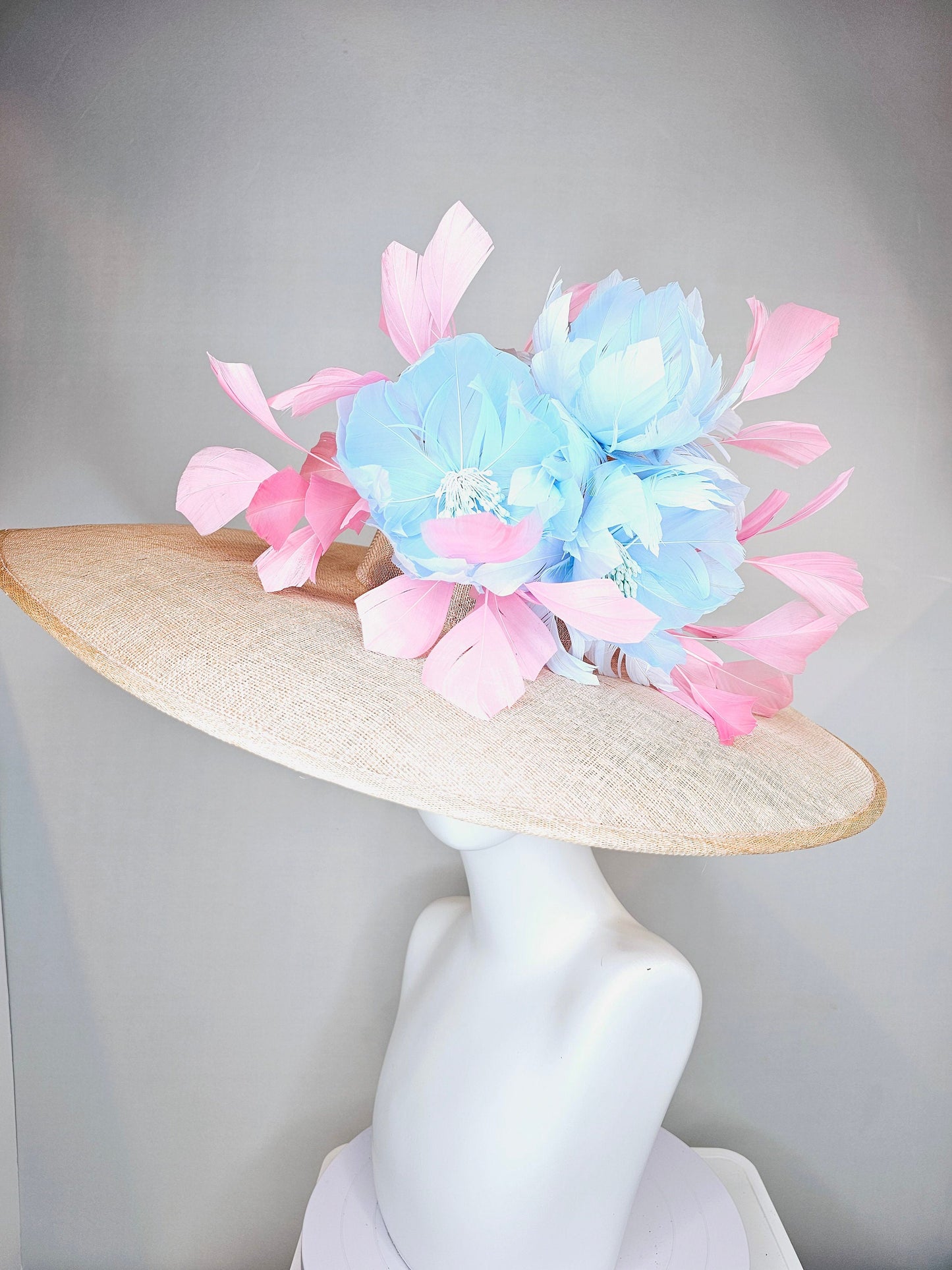 kentucky derby hat large wide brim sinamay neutral beige hat with light baby pink feathers and light baby blue fluffy feather flowers