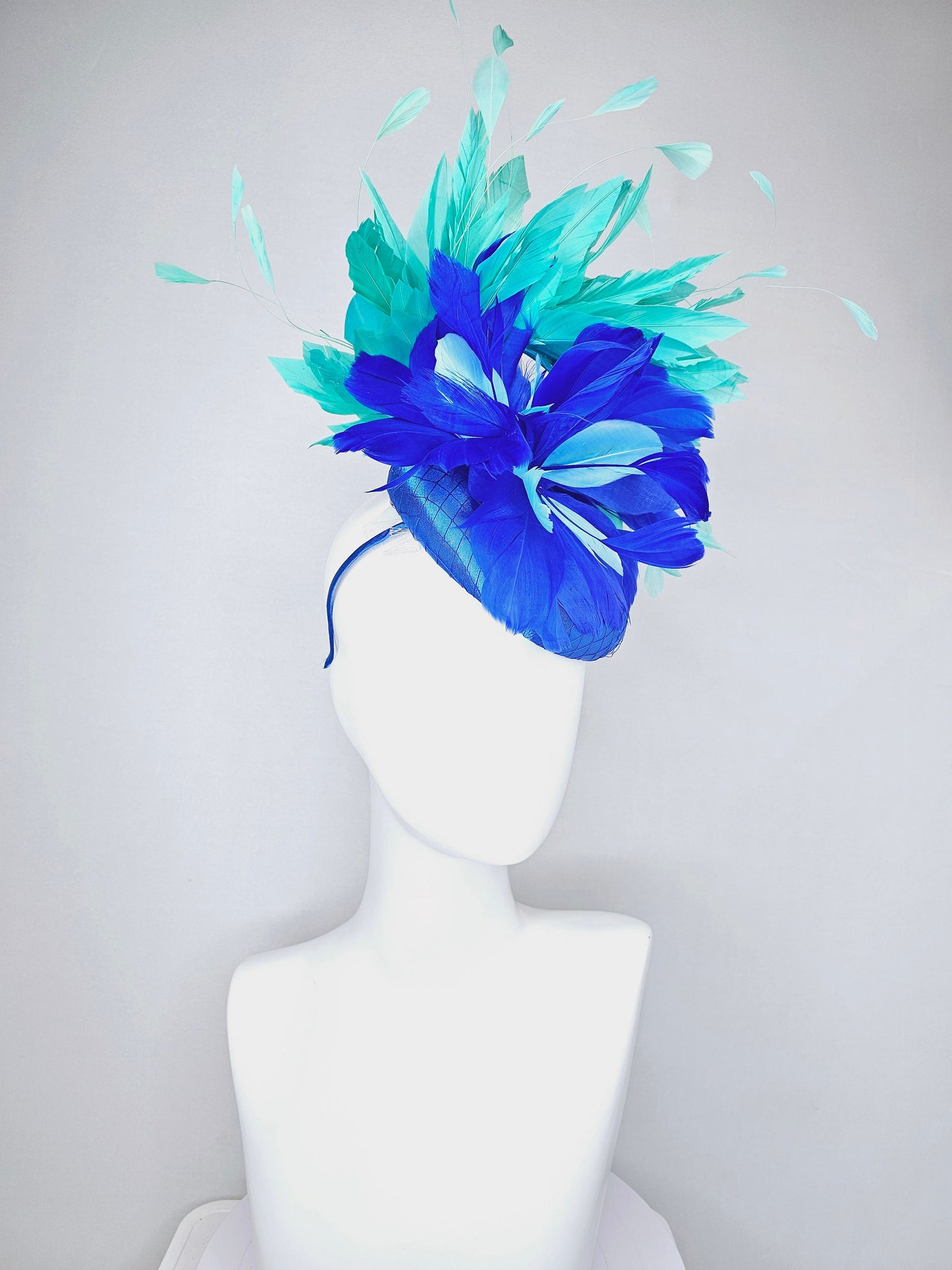 kentucky derby hat fascinator royal blue satin with green feathers and blue green feather flowers