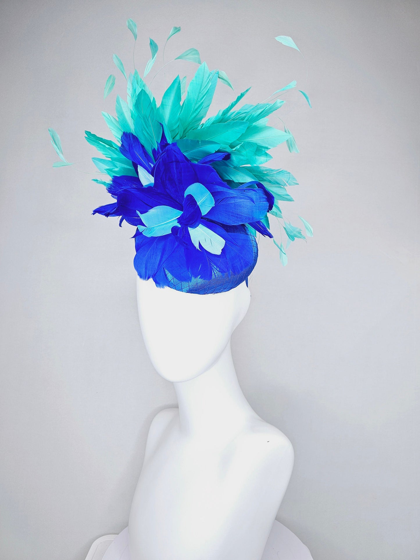 kentucky derby hat fascinator royal blue satin with green feathers and blue green feather flowers