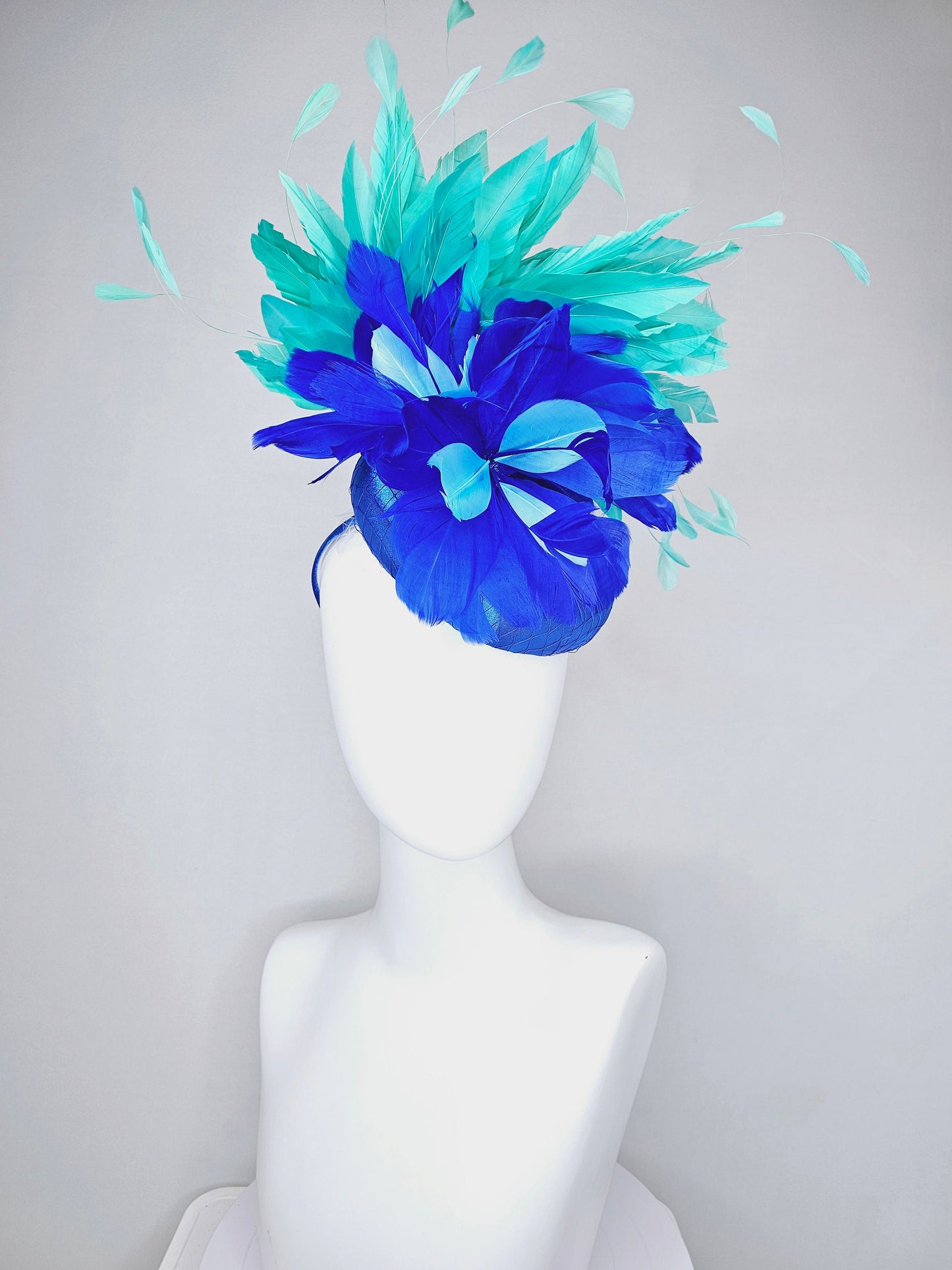 kentucky derby hat fascinator royal blue satin with green feathers and blue green feather flowers