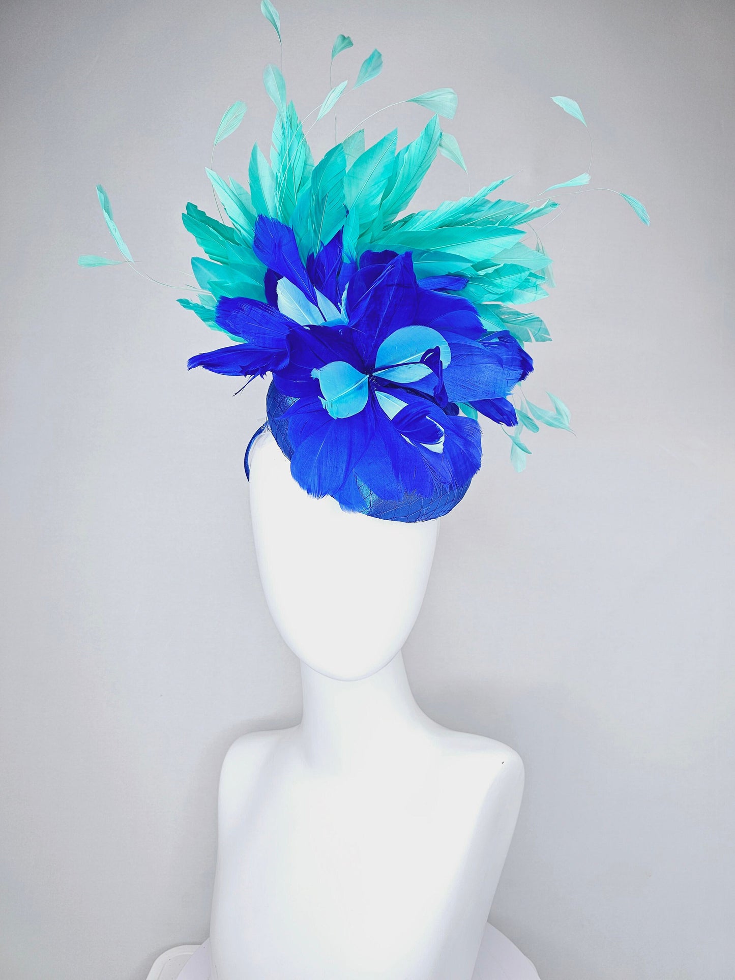 kentucky derby hat fascinator royal blue satin with green feathers and blue green feather flowers