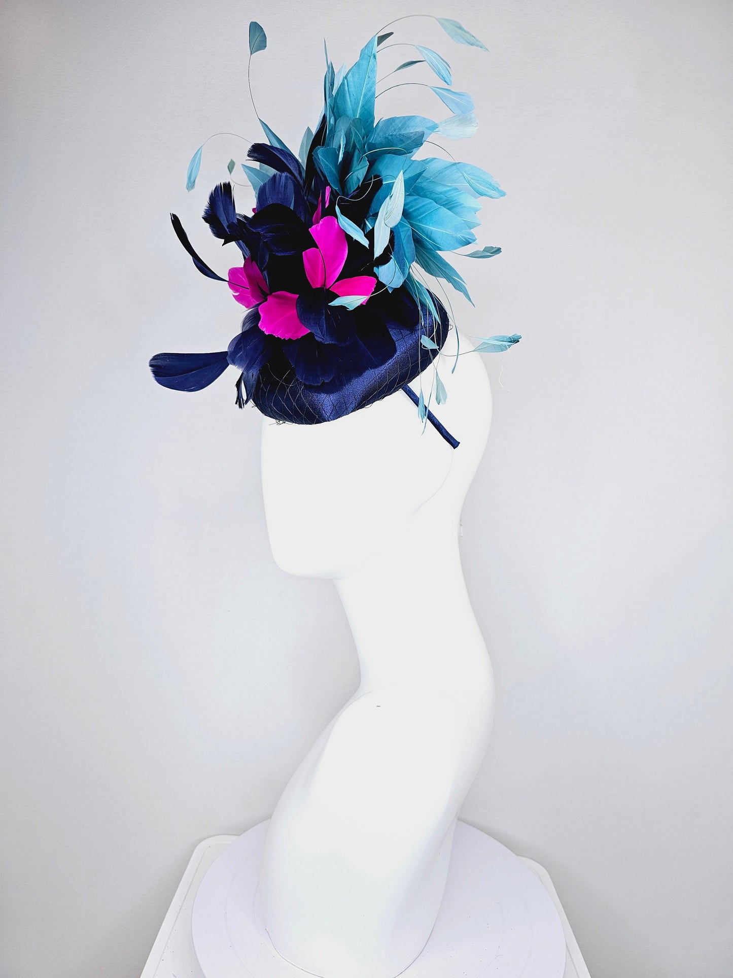 kentucky derby hat fascinator navy blue satin with pink and navy feather flowers with peacock green blue feathers