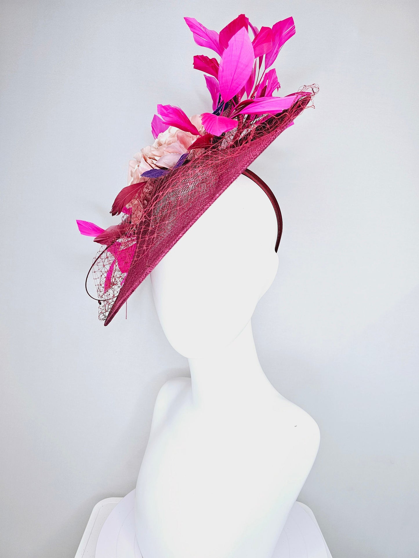 kentucky derby hat fascinator magenta maroon wine saucer with netting mauve pink flowers purple leaves  and fuchsia pink feathers