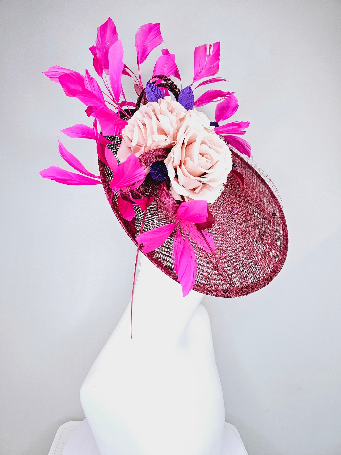 kentucky derby hat fascinator magenta maroon wine saucer with netting mauve pink flowers purple leaves  and fuchsia pink feathers