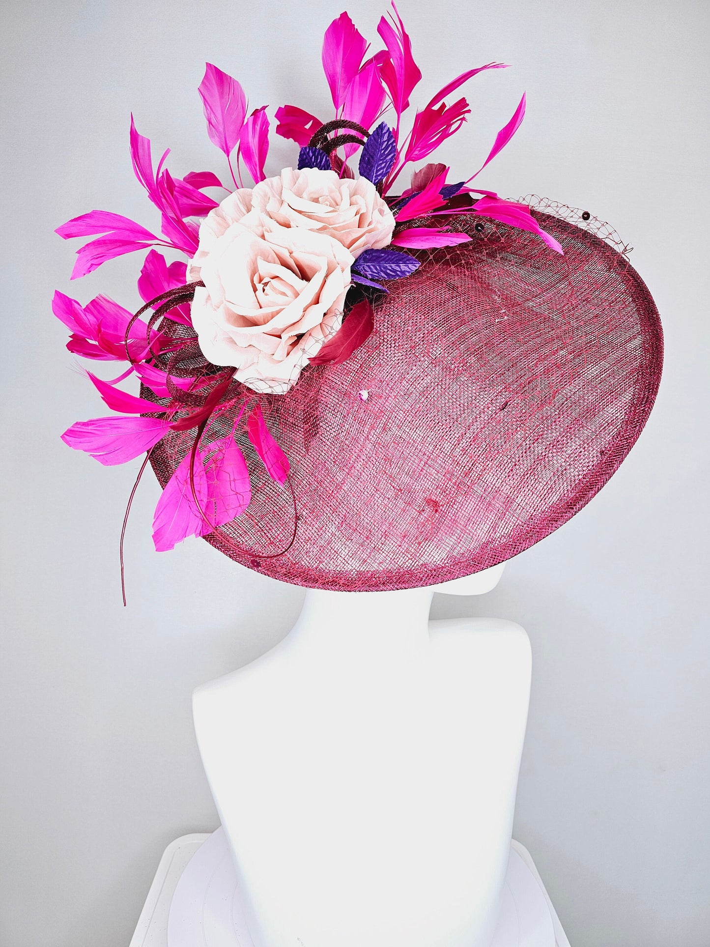 kentucky derby hat fascinator magenta maroon wine saucer with netting mauve pink flowers purple leaves  and fuchsia pink feathers