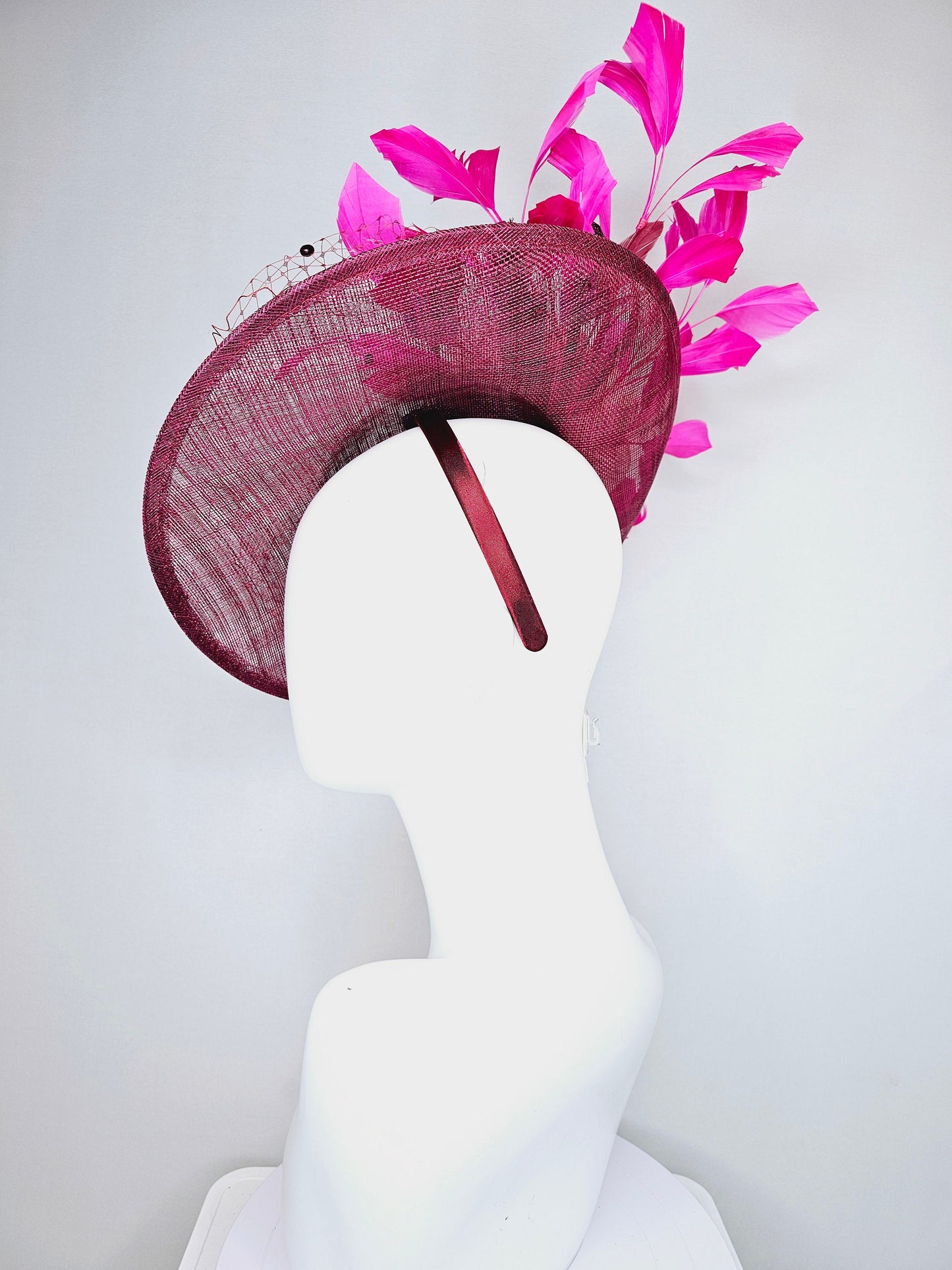 kentucky derby hat fascinator magenta maroon wine saucer with netting mauve pink flowers purple leaves  and fuchsia pink feathers