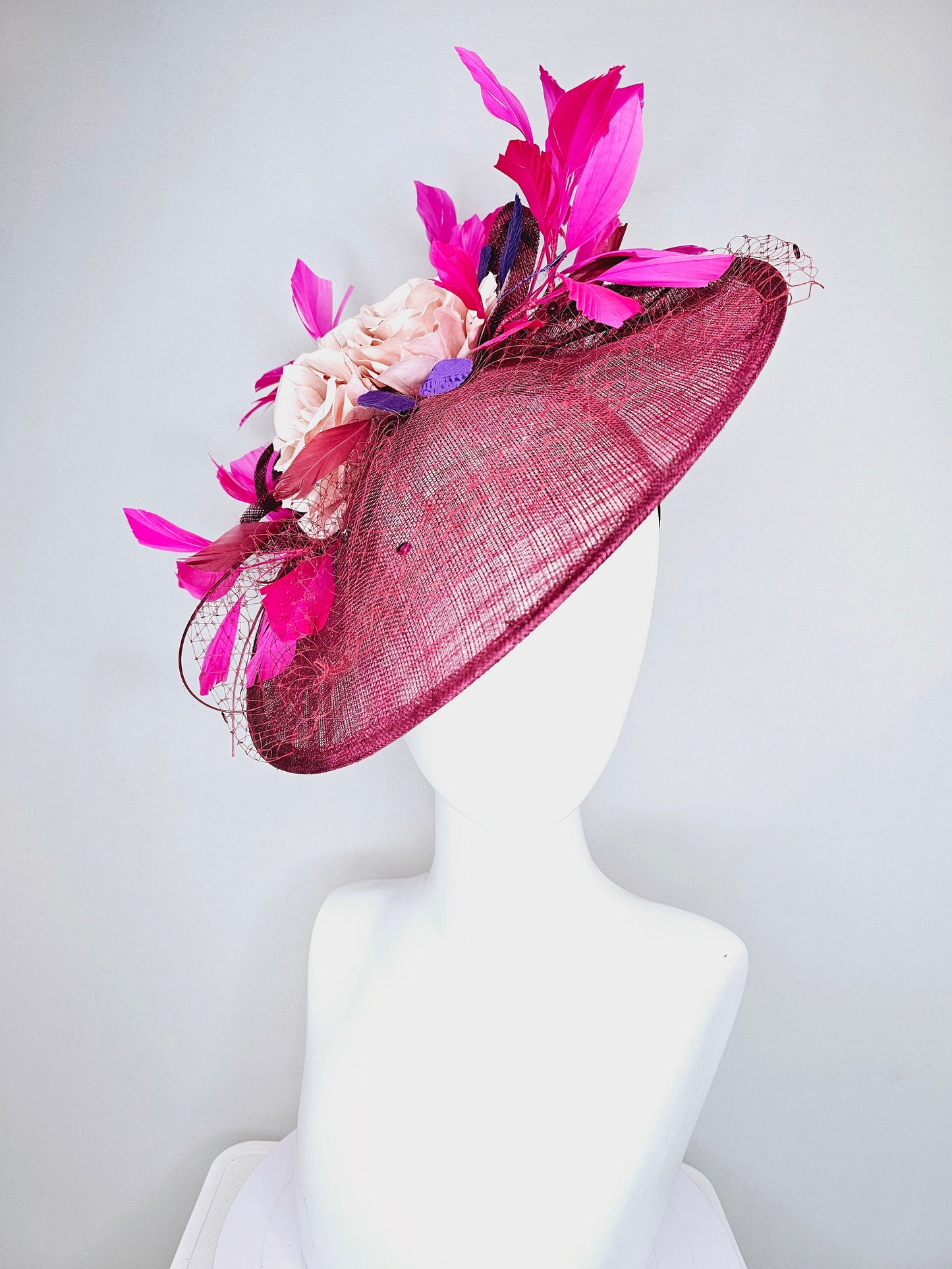 kentucky derby hat fascinator magenta maroon wine saucer with netting mauve pink flowers purple leaves  and fuchsia pink feathers