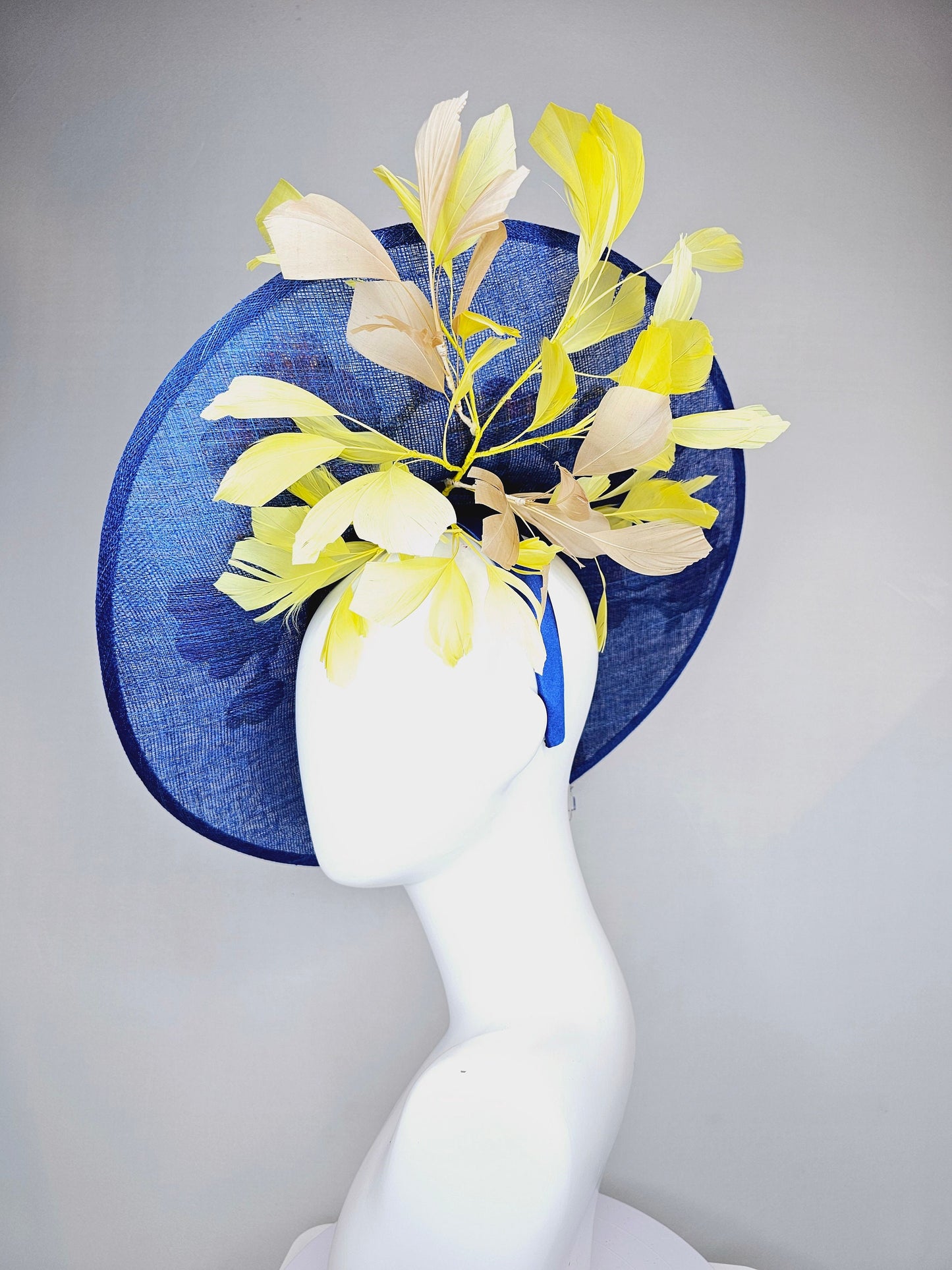 kentucky derby hat fascinator blue sinamay large saucer with yellow and gold taupe feathers and white pink yellow embroidered flowers