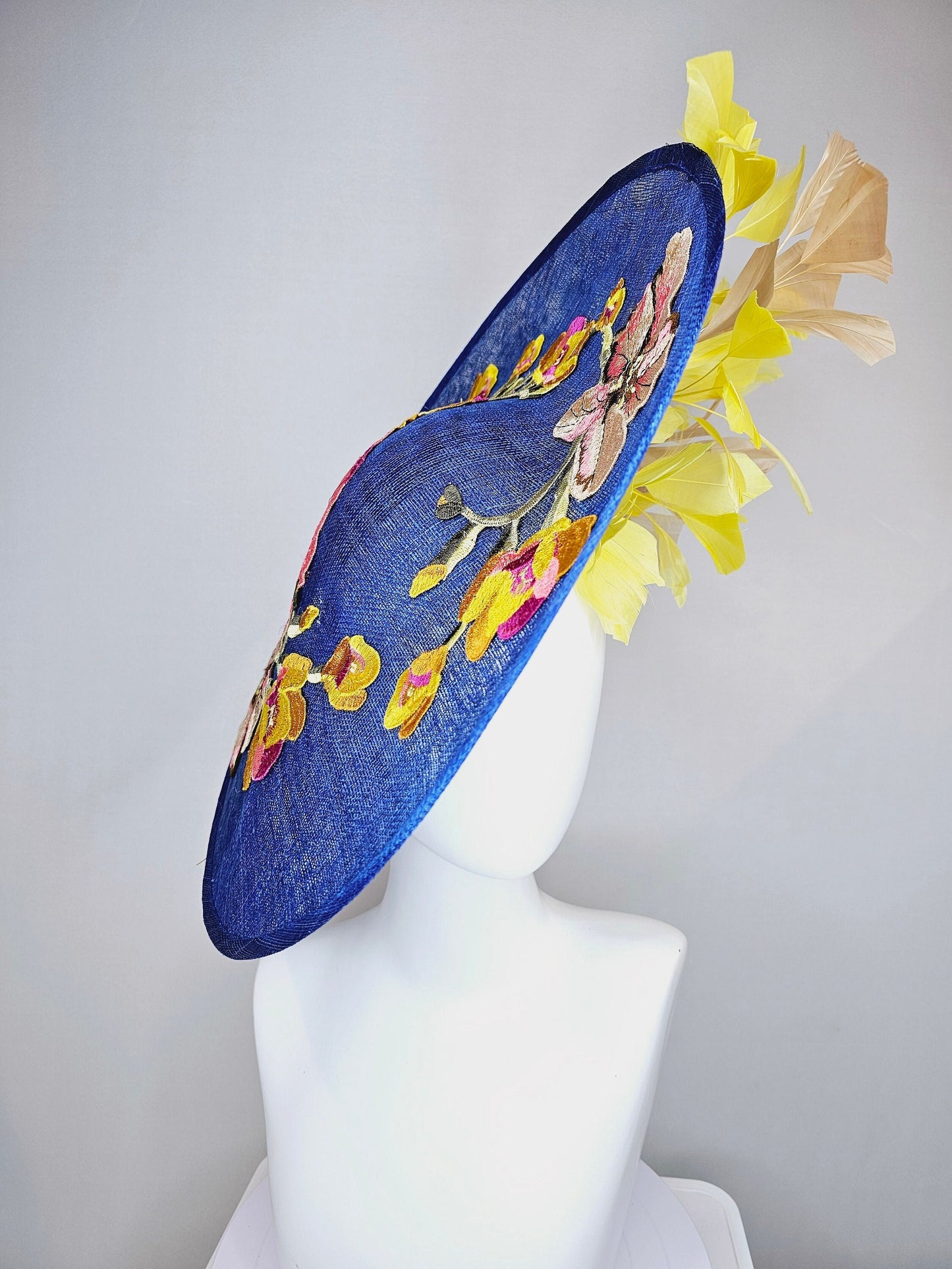 kentucky derby hat fascinator blue sinamay large saucer with yellow and gold taupe feathers and white pink yellow embroidered flowers