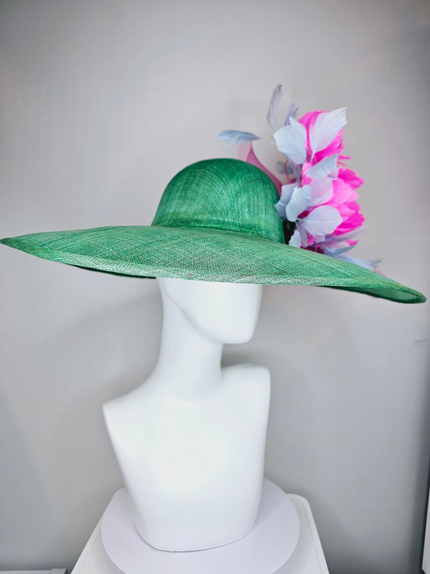 kentucky derby hat large wide brim sinamay emerald green hat with fuchsia pink feather flower and lavender feathers with pink crinoline