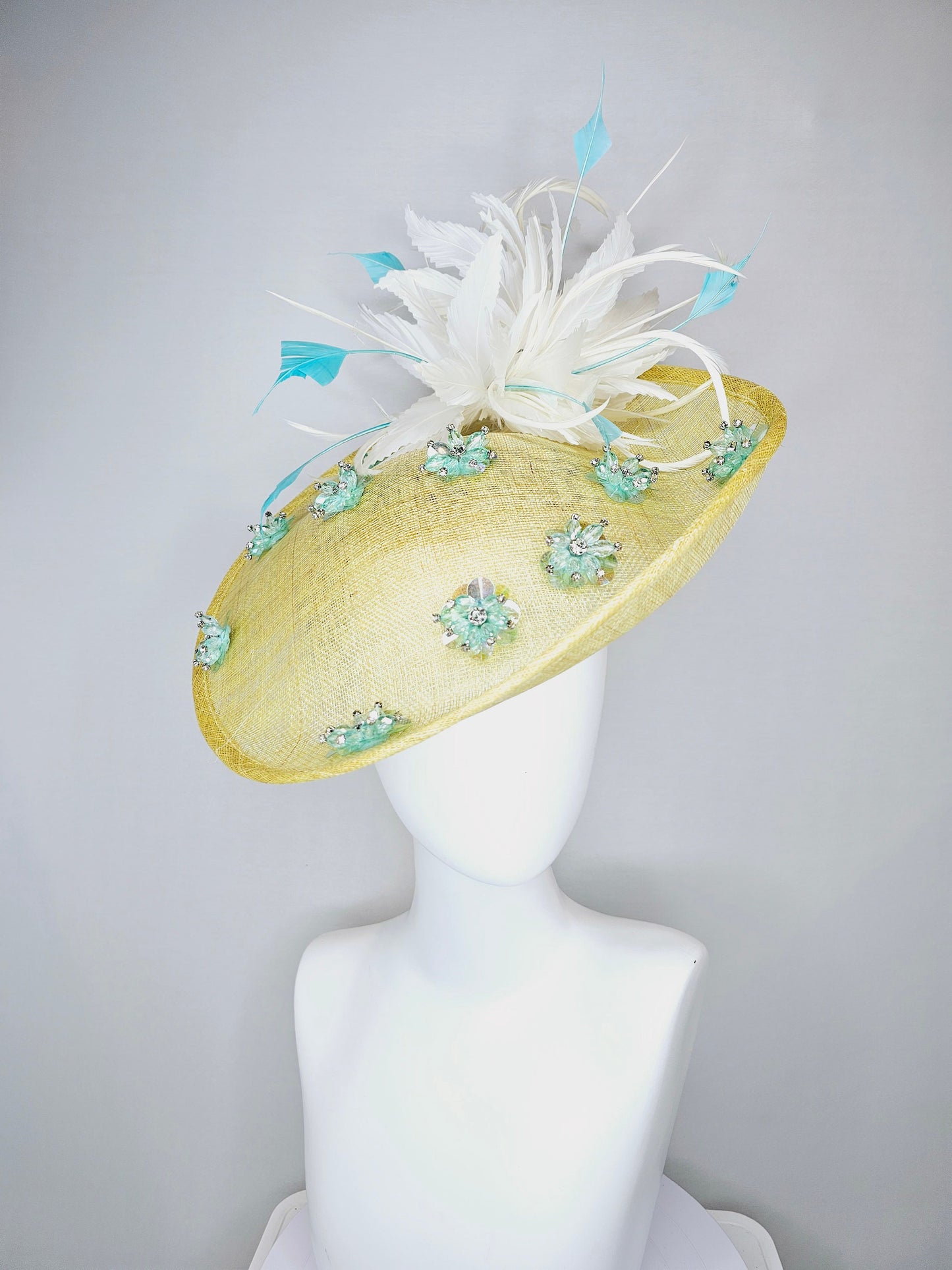 kentucky derby hat fascinator yellow sinamay saucer with white and blue feathers with blue crystal jewel beaded flowers