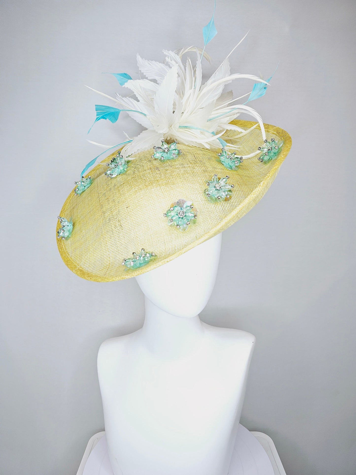 kentucky derby hat fascinator yellow sinamay saucer with white and blue feathers with blue crystal jewel beaded flowers