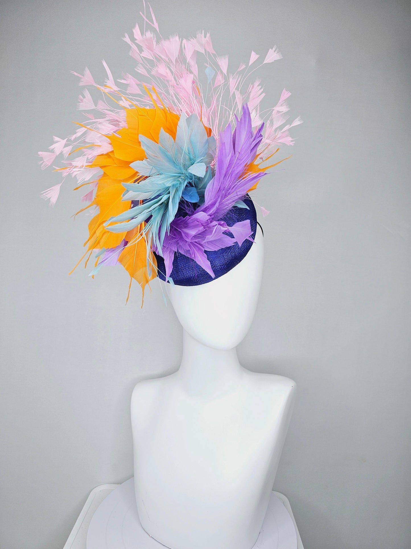 kentucky derby hat fascinator royal blue sinamay with violet purple, teal blue, apricot orange yellow, and baby pink branching feathers