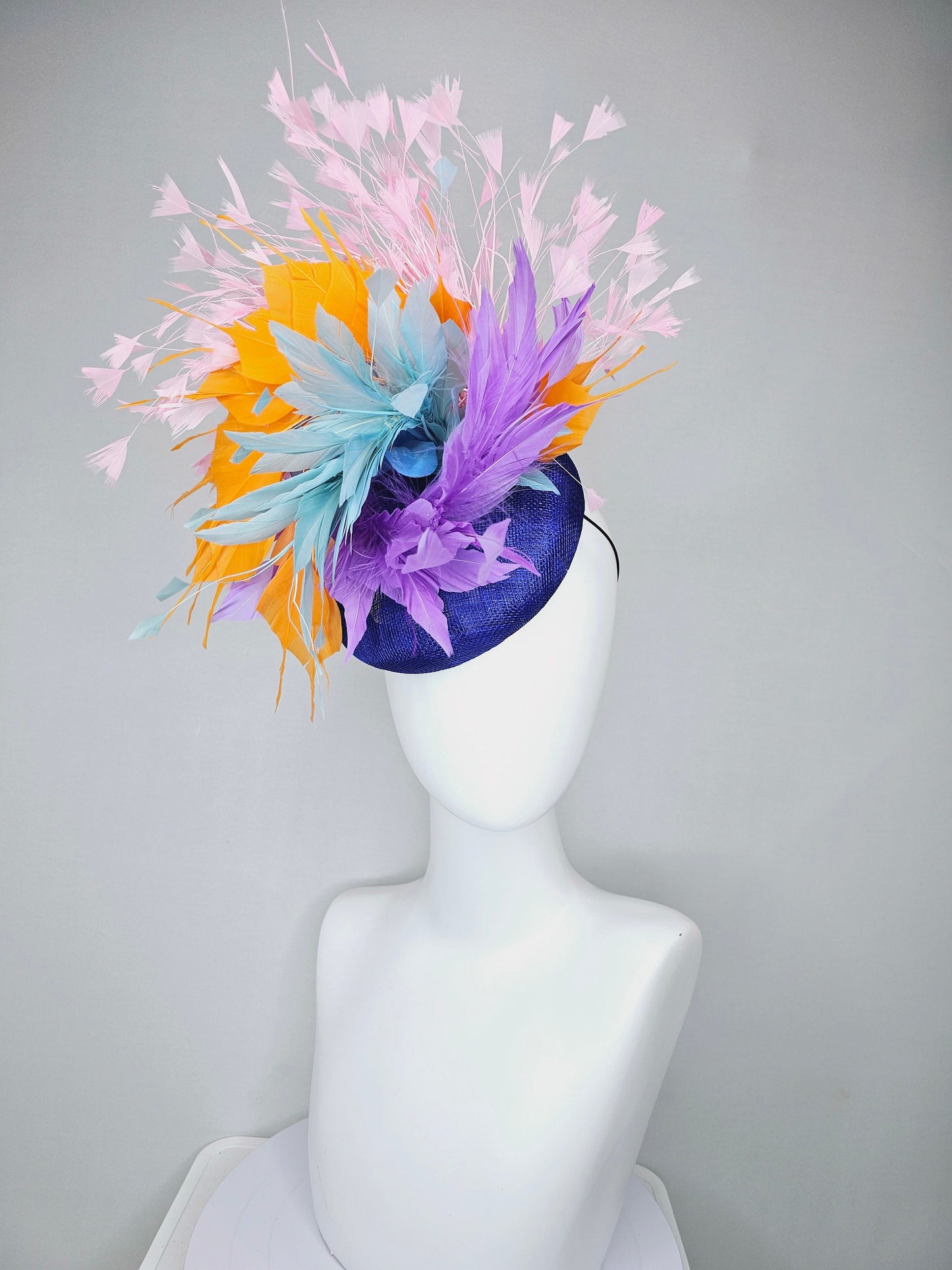 kentucky derby hat fascinator royal blue sinamay with violet purple, teal blue, apricot orange yellow, and baby pink branching feathers