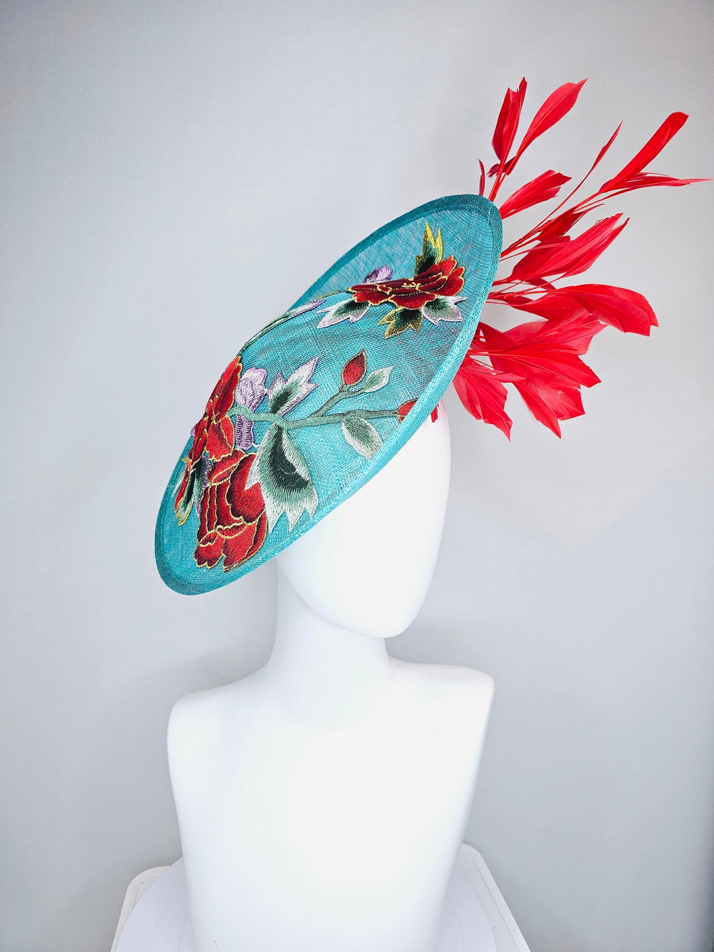 kentucky derby hat fascinator teal turquoise aqua blue sinamay saucer with purple red gold green embroidered flowers with red feathers